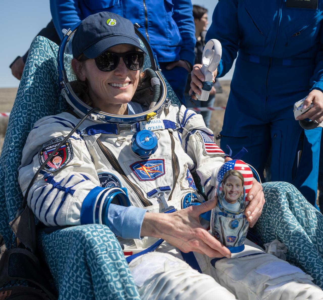 Expedition 70 NASA astronaut Loral O'Hara is seen holding a matryoshka doll that was gifted to her outside the Soyuz MS-24 spacecraft after she, Roscosmos cosmonaut Oleg Novitskiy, and Belarus spaceflight participant Marina Vasilevskaya landed in a remote area near the town of Zhezkazgan, Kazakhstan on Saturday, April 6, 2024. O’Hara is returning to Earth after logging 204 days in space as a member of Expeditions 69-70 aboard the International Space Station and Novitskiy and Vasilevskaya return after having spent the last 14 days in space. Photo Credit (NASA/Bill Ingalls)