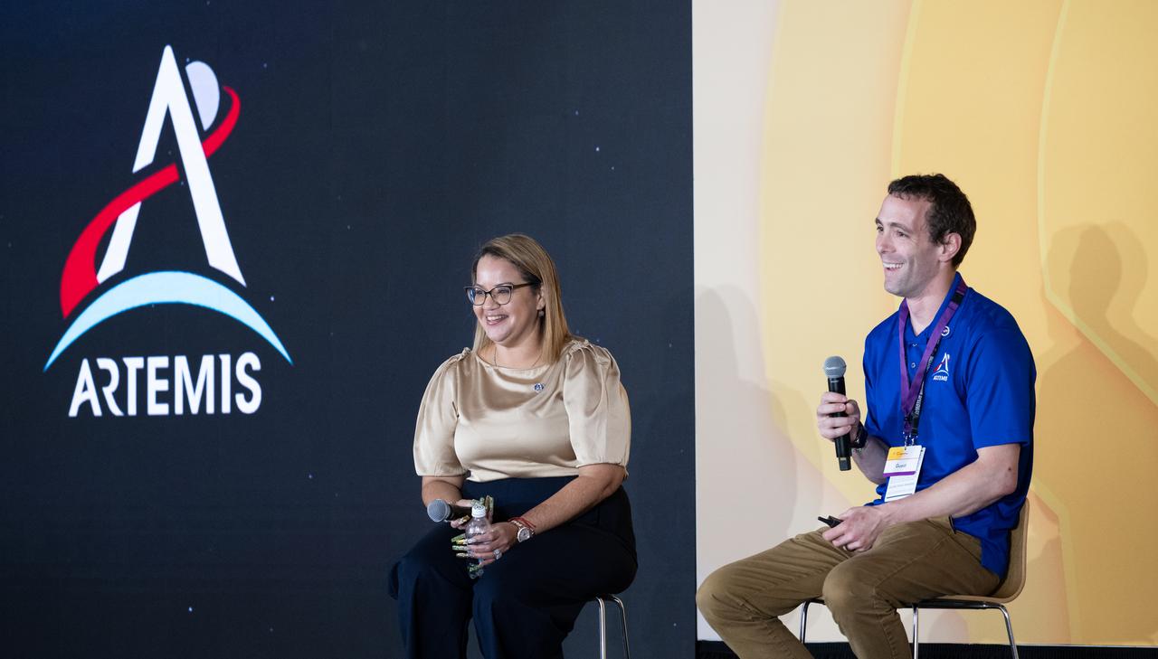 Dr. Dionne Hernandez-Lugo, Power and Propulsion Element Contracting Officer Representative in the Gateway & Power and Propulsion Element Office of NASA's Exploration Systems Development Mission Directorate, left, and Logan Kennedy, surface lead for Human Landing System Programs in NASA's Exploration Systems Development Mission Directorate, right, speaks to students about power production and energy for the Artemis Program at the Shell Eco-marathon Americas, Saturday, April 6, 2024, at the Indianapolis Motor Speedway in Indianapolis, Ind. Photo Credit: (NASA/Joel Kowsky)