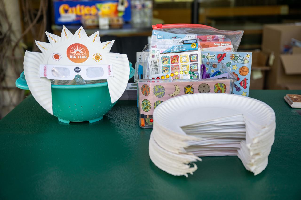 A solar eclipse glasses crafting station is seen at the Dallas Arboretum, Sunday, April 7, 2024, in Dallas, Texas. On Monday, April 8, a total solar eclipse will sweep across a narrow portion of the North American continent from Mexico’s Pacific coast to the Atlantic coast of Newfoundland, Canada, while a partial solar eclipse will be visible across the entire North American continent along with parts of Central America and Europe. Photo Credit: (NASA/Keegan Barber)