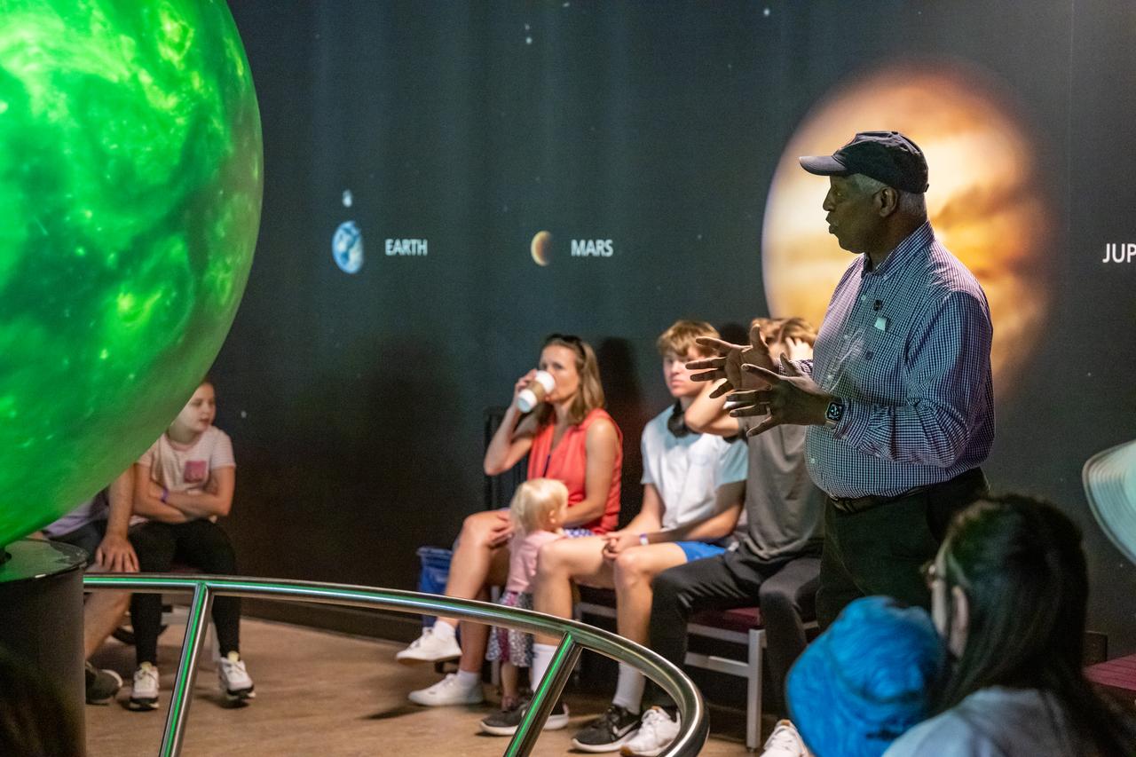 Maurice Henderson speaks to guests about the upcoming total solar eclipse at the Dallas Arboretum, Sunday, April 7, 2024, in Dallas, Texas. On Monday, April 8, a total solar eclipse will sweep across a narrow portion of the North American continent from Mexico’s Pacific coast to the Atlantic coast of Newfoundland, Canada, while a partial solar eclipse will be visible across the entire North American continent along with parts of Central America and Europe. Photo Credit: (NASA/Keegan Barber)