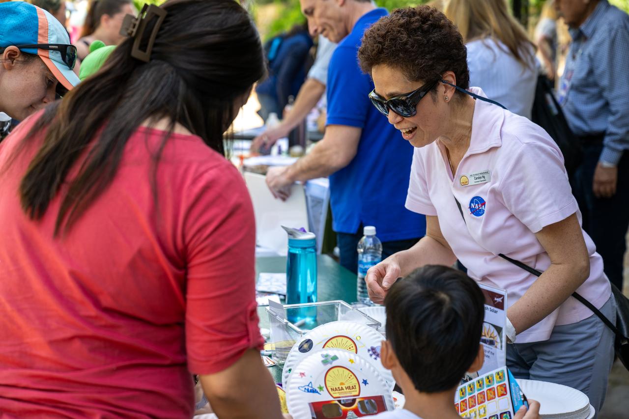 NASA Principal Scientist Carolyn Ng speaks to guests about the upcoming total solar eclipse at the Dallas Arboretum, Sunday, April 7, 2024, in Dallas, Texas. On Monday, April 8, a total solar eclipse will sweep across a narrow portion of the North American continent from Mexico’s Pacific coast to the Atlantic coast of Newfoundland, Canada, while a partial solar eclipse will be visible across the entire North American continent along with parts of Central America and Europe. Photo Credit: (NASA/Keegan Barber)