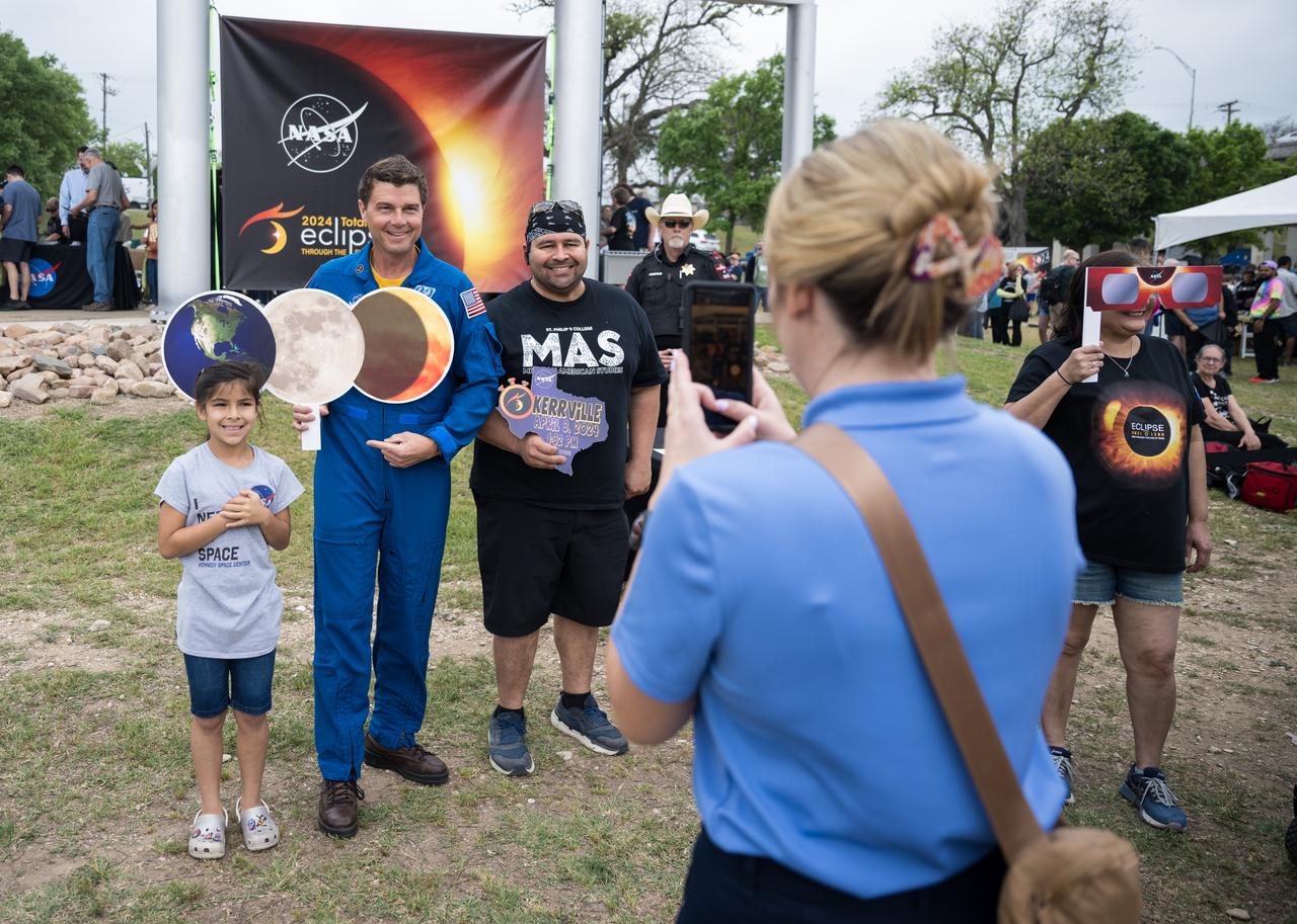 Astronaut Reid Wiseman poses for a photo with guests at the total solar eclipse festival in Kerrville, TX on Monday, April 8, 2024. A total solar eclipse swept across a narrow portion of the North American continent from Mexico’s Pacific coast to the Atlantic coast of Newfoundland, Canada. A partial solar eclipse was visible across the entire North American continent along with parts of Central America and Europe.  Photo Credit: (NASA/Aubrey Gemignani)