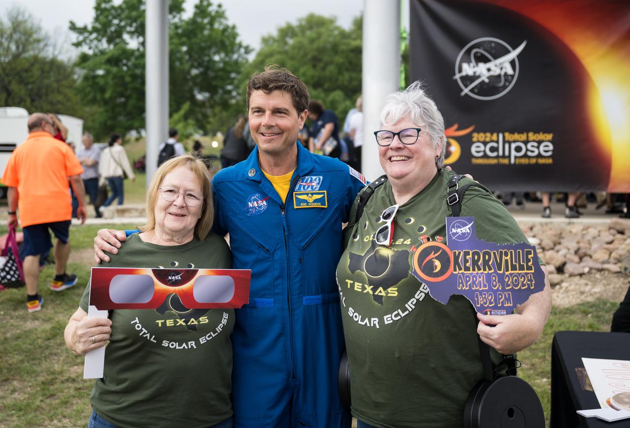 Astronaut Reid Wiseman poses for a photo with guests at the total solar eclipse festival in Kerrville, TX on Monday, April 8, 2024. A total solar eclipse swept across a narrow portion of the North American continent from Mexico’s Pacific coast to the Atlantic coast of Newfoundland, Canada. A partial solar eclipse was visible across the entire North American continent along with parts of Central America and Europe. Photo Credit: (NASA/Aubrey Gemignani)