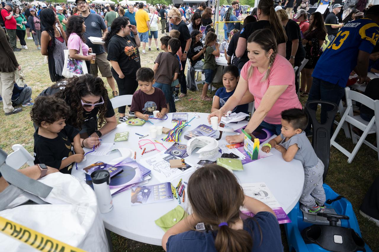 Guests work on art projects during the Kerrville eclipse festival in Kerrville, TX on Monday, April 8, 2024. A total solar eclipse swept across a narrow portion of the North American continent from Mexico’s Pacific coast to the Atlantic coast of Newfoundland, Canada. A partial solar eclipse was visible across the entire North American continent along with parts of Central America and Europe.  Photo Credit: (NASA/Aubrey Gemignani)