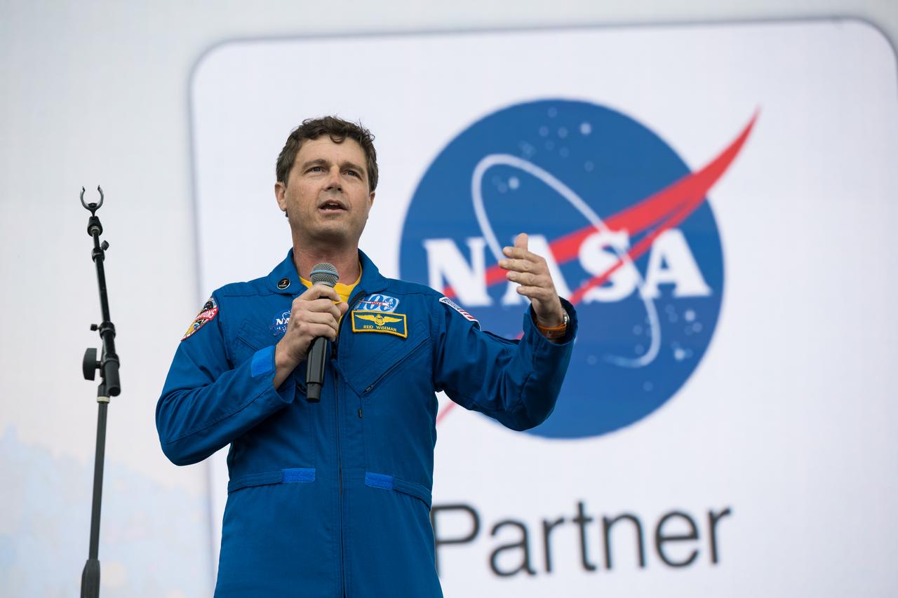 Astronaut Reid Wiseman speaks on the main stage at the Kerrville eclipse festival in Kerrville, TX on Monday, April 8, 2024. A total solar eclipse swept across a narrow portion of the North American continent from Mexico’s Pacific coast to the Atlantic coast of Newfoundland, Canada. A partial solar eclipse was visible across the entire North American continent along with parts of Central America and Europe.  Photo Credit: (NASA/Aubrey Gemignani)