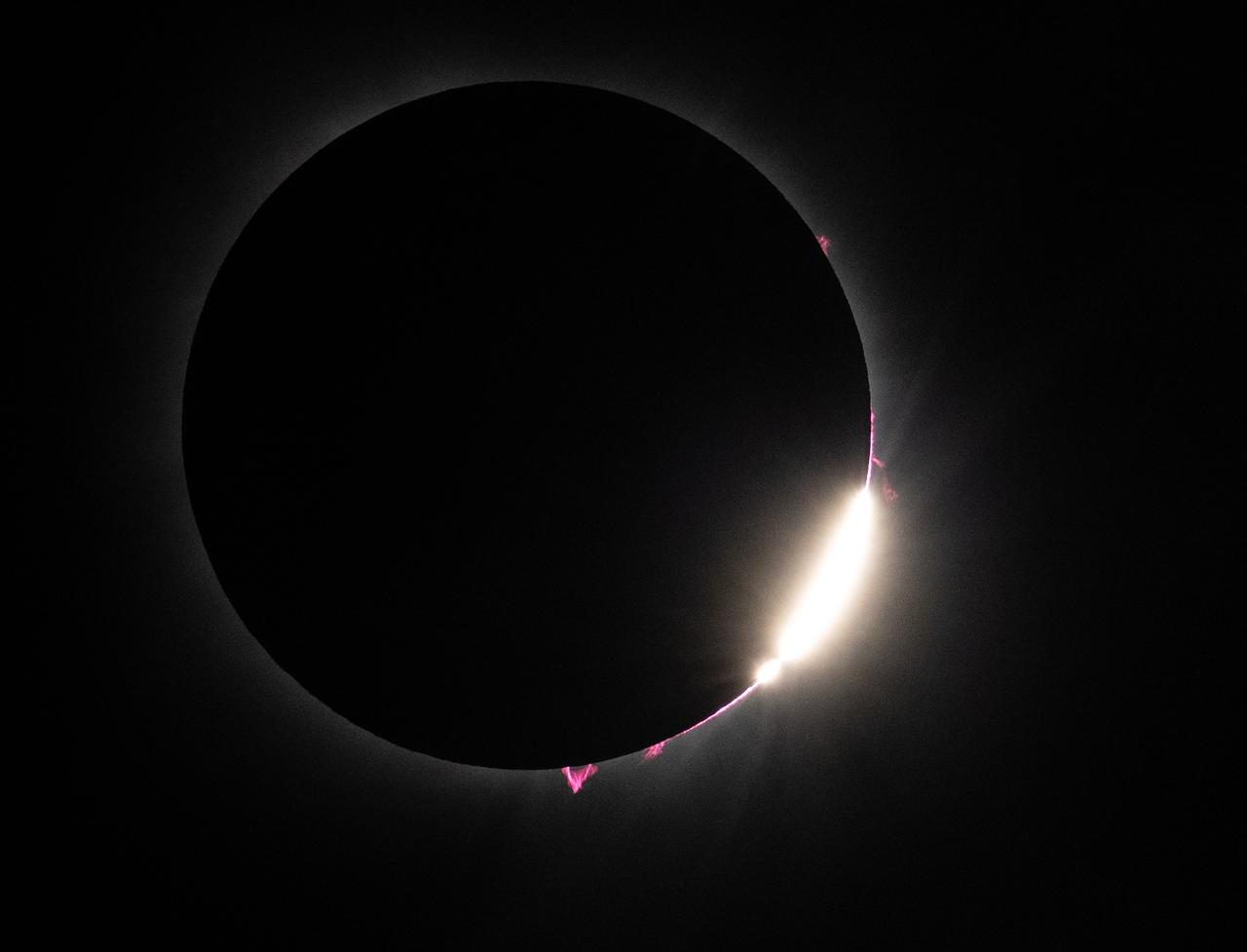 Bailey's Beads and solar prominences are seen just after totality in Dallas, Texas on Monday, April 8, 2024. A total solar eclipse swept across a narrow portion of the North American continent from Mexico’s Pacific coast to the Atlantic coast of Newfoundland, Canada. A partial solar eclipse was visible across the entire North American continent along with parts of Central America and Europe. Photo Credit: (NASA/Keegan Barber) in Dallas, Texas on Monday, April 8, 2024. A total solar eclipse swept across a narrow portion of the North American continent from Mexico’s Pacific coast to the Atlantic coast of Newfoundland, Canada. A partial solar eclipse was visible across the entire North American continent along with parts of Central America and Europe. Photo Credit: (NASA/Keegan Barber)