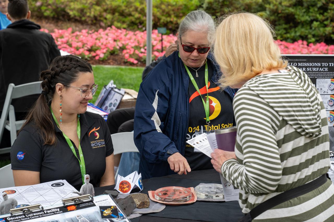 Guests learn about the total solar eclipse from NASA staff at the Dallas Arboretum, Monday, April 8, 2024, in Dallas, Texas. A total solar eclipse swept across a narrow portion of the North American continent from Mexico’s Pacific coast to the Atlantic coast of Newfoundland, Canada. A partial solar eclipse was visible across the entire North American continent along with parts of Central America and Europe. Photo Credit: (NASA/Keegan Barber) in Dallas, Texas on Monday, April 8, 2024. A total solar eclipse swept across a narrow portion of the North American continent from Mexico’s Pacific coast to the Atlantic coast of Newfoundland, Canada. A partial solar eclipse was visible across the entire North American continent along with parts of Central America and Europe. Photo Credit: (NASA/Keegan Barber)