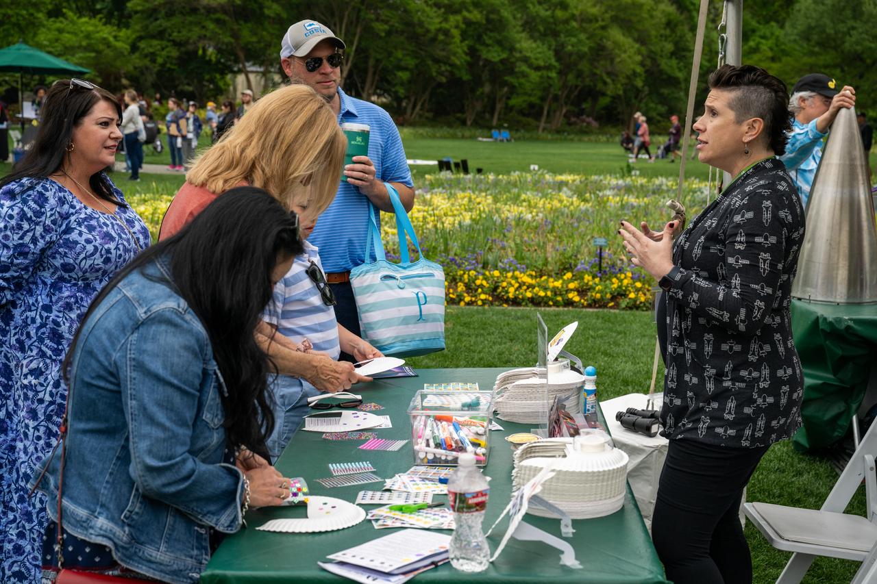 Guests learn about the total solar eclipse from NASA staff at the Dallas Arboretum, Monday, April 8, 2024, in Dallas, Texas. A total solar eclipse swept across a narrow portion of the North American continent from Mexico’s Pacific coast to the Atlantic coast of Newfoundland, Canada. A partial solar eclipse was visible across the entire North American continent along with parts of Central America and Europe. Photo Credit: (NASA/Keegan Barber) in Dallas, Texas on Monday, April 8, 2024. A total solar eclipse swept across a narrow portion of the North American continent from Mexico’s Pacific coast to the Atlantic coast of Newfoundland, Canada. A partial solar eclipse was visible across the entire North American continent along with parts of Central America and Europe. Photo Credit: (NASA/Keegan Barber)