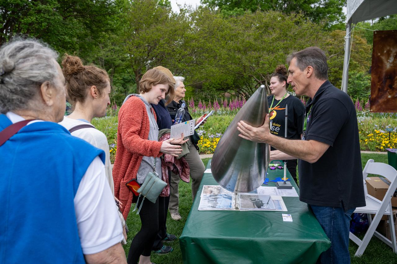 Guests learn about the total solar eclipse from NASA staff at the Dallas Arboretum, Monday, April 8, 2024, in Dallas, Texas. A total solar eclipse swept across a narrow portion of the North American continent from Mexico’s Pacific coast to the Atlantic coast of Newfoundland, Canada. A partial solar eclipse was visible across the entire North American continent along with parts of Central America and Europe. Photo Credit: (NASA/Keegan Barber) in Dallas, Texas on Monday, April 8, 2024. A total solar eclipse swept across a narrow portion of the North American continent from Mexico’s Pacific coast to the Atlantic coast of Newfoundland, Canada. A partial solar eclipse was visible across the entire North American continent along with parts of Central America and Europe. Photo Credit: (NASA/Keegan Barber)