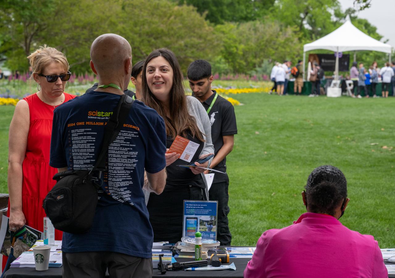 Guests learn about the total solar eclipse from NASA staff at the Dallas Arboretum, Monday, April 8, 2024, in Dallas, Texas. A total solar eclipse swept across a narrow portion of the North American continent from Mexico’s Pacific coast to the Atlantic coast of Newfoundland, Canada. A partial solar eclipse was visible across the entire North American continent along with parts of Central America and Europe. Photo Credit: (NASA/Keegan Barber) in Dallas, Texas on Monday, April 8, 2024. A total solar eclipse swept across a narrow portion of the North American continent from Mexico’s Pacific coast to the Atlantic coast of Newfoundland, Canada. A partial solar eclipse was visible across the entire North American continent along with parts of Central America and Europe. Photo Credit: (NASA/Keegan Barber)