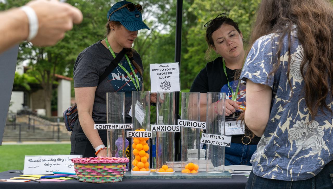 Guests learn about the total solar eclipse from NASA staff at the Dallas Arboretum, Monday, April 8, 2024, in Dallas, Texas. A total solar eclipse swept across a narrow portion of the North American continent from Mexico’s Pacific coast to the Atlantic coast of Newfoundland, Canada. A partial solar eclipse was visible across the entire North American continent along with parts of Central America and Europe. Photo Credit: (NASA/Keegan Barber) in Dallas, Texas on Monday, April 8, 2024. A total solar eclipse swept across a narrow portion of the North American continent from Mexico’s Pacific coast to the Atlantic coast of Newfoundland, Canada. A partial solar eclipse was visible across the entire North American continent along with parts of Central America and Europe. Photo Credit: (NASA/Keegan Barber)