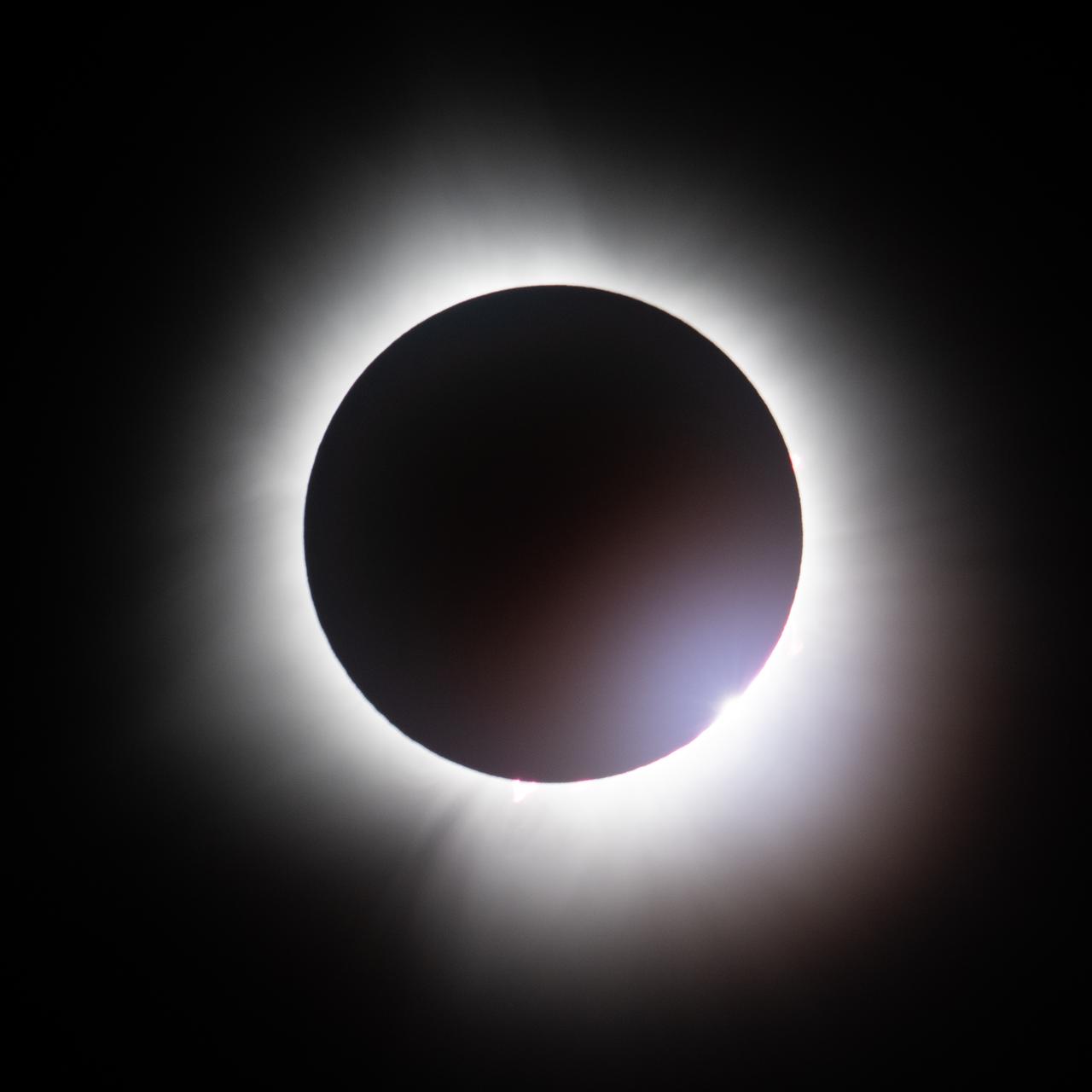A total solar eclipse is seen from the Indianapolis Motor Speedway, Monday, April 8, 2024, in Indianapolis, Indiana. A total solar eclipse swept across a narrow portion of the North American continent from Mexico’s Pacific coast to the Atlantic coast of Newfoundland, Canada. A partial solar eclipse was visible across the entire North American continent along with parts of Central America and Europe.  Photo Credit: (NASA/Joel Kowsky)