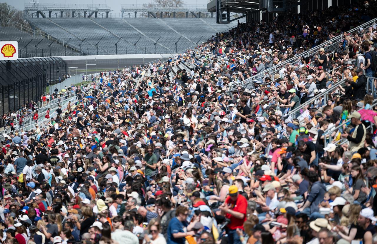 Attendees are seen in the grandstands of the Indianapolis Motor Speedway ahead of a total solar eclipse, Monday, April 8, 2024, in Indianapolis, Indiana. A total solar eclipse swept across a narrow portion of the North American continent from Mexico’s Pacific coast to the Atlantic coast of Newfoundland, Canada. A partial solar eclipse was visible across the entire North American continent along with parts of Central America and Europe.  Photo Credit: (NASA/Joel Kowsky)