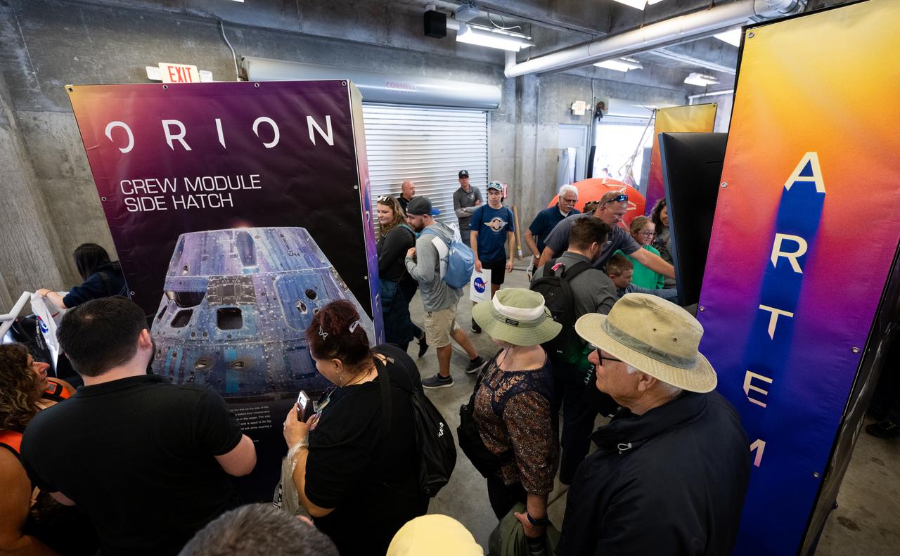Attendees at the Indianapolis Motor Speedway view NASA exhibits ahead of the total solar eclipse, Monday, April 8, 2024, in Indianapolis, Ind. A total solar eclipse swept across a narrow portion of the North American continent from Mexico’s Pacific coast to the Atlantic coast of Newfoundland, Canada. A partial solar eclipse was visible across the entire North American continent along with parts of Central America and Europe.  Photo Credit: (NASA/Joel Kowsky)