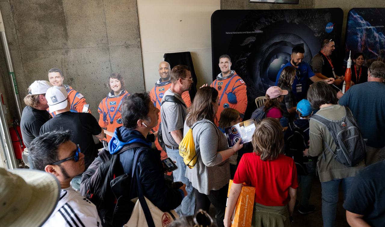 Life-size cutouts of Artemis II crewmembers NASA astronauts Reid Wiseman, Christina Koch, Victor Glover, and Canadian Space Agency astronaut Jermey Hansen are seen as attendees at the Indianapolis Motor Speedway view NASA exhibits ahead of the total solar eclipse, Monday, April 8, 2024, in Indianapolis, Ind. A total solar eclipse swept across a narrow portion of the North American continent from Mexico’s Pacific coast to the Atlantic coast of Newfoundland, Canada. A partial solar eclipse was visible across the entire North American continent along with parts of Central America and Europe.  Photo Credit: (NASA/Joel Kowsky)
