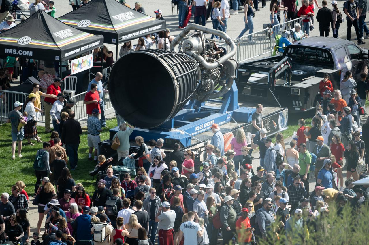 Attendees at the Indianapolis Motor Speedway view an RS-25 engine ahead of the total solar eclipse, Monday, April 8, 2024, in Indianapolis, Ind. A total solar eclipse swept across a narrow portion of the North American continent from Mexico’s Pacific coast to the Atlantic coast of Newfoundland, Canada. A partial solar eclipse was visible across the entire North American continent along with parts of Central America and Europe.  Photo Credit: (NASA/Joel Kowsky)