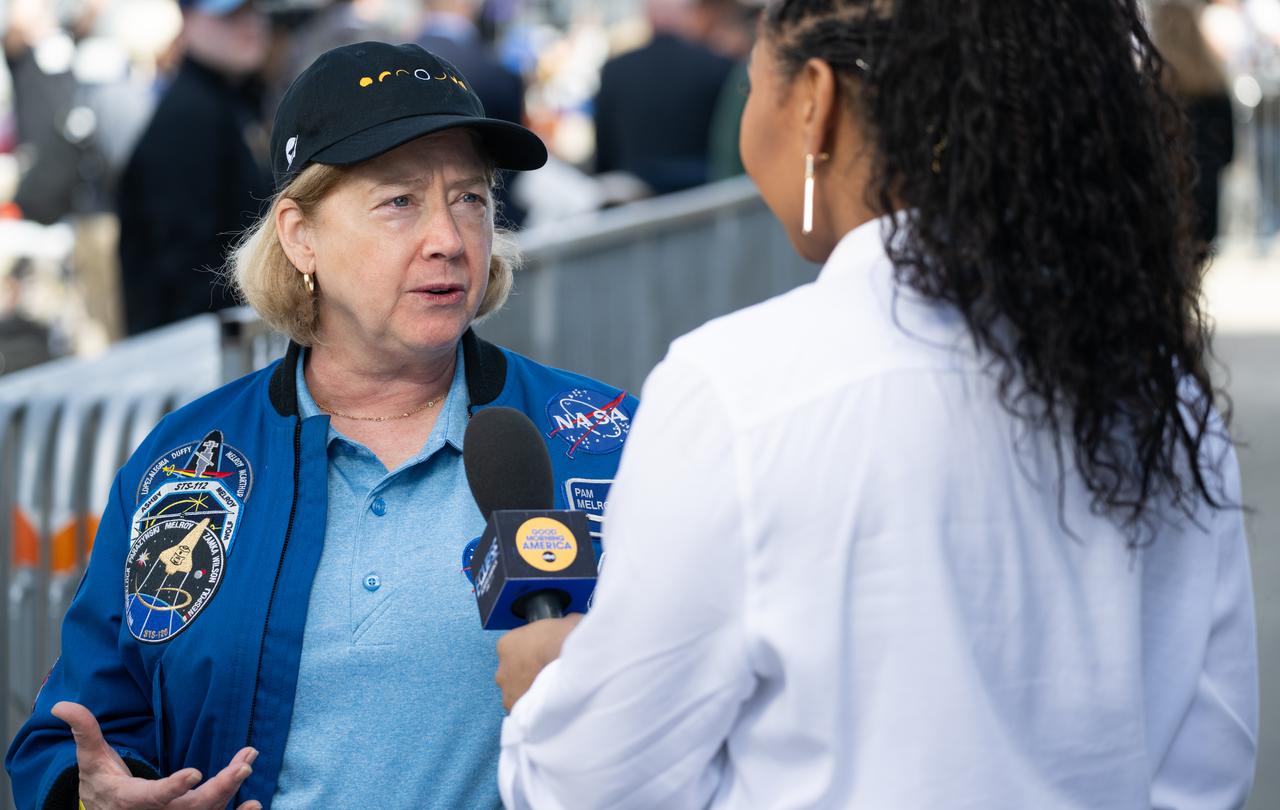 NASA Deputy Administrator Pam Melroy speaks to ABC News meteorologist Somara Theodore at the Indianapolis Motor Speedway ahead of the total solar eclipse, Monday, April 8, 2024, in Indianapolis, Ind. A total solar eclipse swept across a narrow portion of the North American continent from Mexico’s Pacific coast to the Atlantic coast of Newfoundland, Canada. A partial solar eclipse was visible across the entire North American continent along with parts of Central America and Europe.  Photo Credit: (NASA/Joel Kowsky)