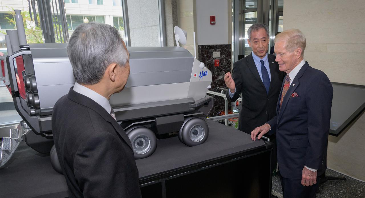 Japan’s Minister of Education, Culture, Sports, Science and Technology Masahito Moriyama, left, Japan Aerospace Exploration Agency (JAXA) President Hiroshi Yamakawa, and NASA Administrator Bill Nelson, right, look at a model of the Pressurized lunar rover, prior to the signing an historic agreement between the United States and Japan to advance sustainable human exploration of the Moon, Tuesday, April 9, 2024, at the NASA Headquarters Mary W. Jackson Building in Washington. Under the agreement, Japan will design, develop, and operate a pressurized rover for crewed and uncrewed exploration on the Moon. NASA will provide the launch and delivery of the rover to the Moon as well as two Japanese astronaut missions to the lunar surface. Photo Credit: (NASA/Bill Ingalls)