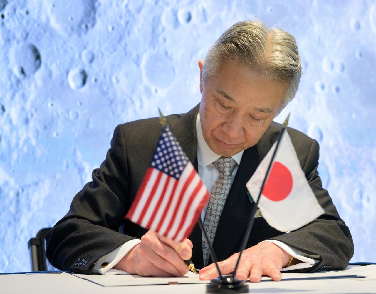 Japan’s Minister of Education, Culture, Sports, Science and Technology Masahito Moriyama, signs an historic agreement between the United States and Japan to advance sustainable human exploration of the Moon, Tuesday, April 9, 2024, at the NASA Headquarters Mary W. Jackson Building in Washington. Under the agreement, Japan will design, develop, and operate a pressurized rover for crewed and uncrewed exploration on the Moon. NASA will provide the launch and delivery of the rover to the Moon as well as two Japanese astronaut missions to the lunar surface. Photo Credit: (NASA/Bill Ingalls)