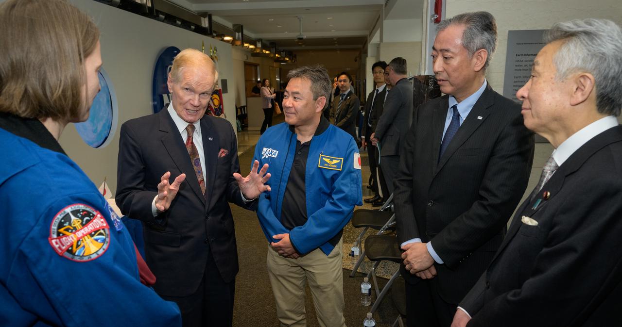 NASA astronaut Kayla Barron, left, NASA Administrator Bill Nelson, JAXA astronaut Akihiko Hoshide, Japan Aerospace Exploration Agency (JAXA) President Hiroshi Yamakawa, and Japan’s Minister of Education, Culture, Sports, Science and Technology Masahito Moriyama, right, talk after the signing of an historic agreement between the United States and Japan to advance sustainable human exploration of the Moon, Tuesday, April 9, 2024, at the NASA Headquarters Mary W. Jackson Building in Washington. Under the agreement, Japan will design, develop, and operate a pressurized rover for crewed and uncrewed exploration on the Moon. NASA will provide the launch and delivery of the rover to the Moon as well as two Japanese astronaut missions to the lunar surface. Photo Credit: (NASA/Bill Ingalls)