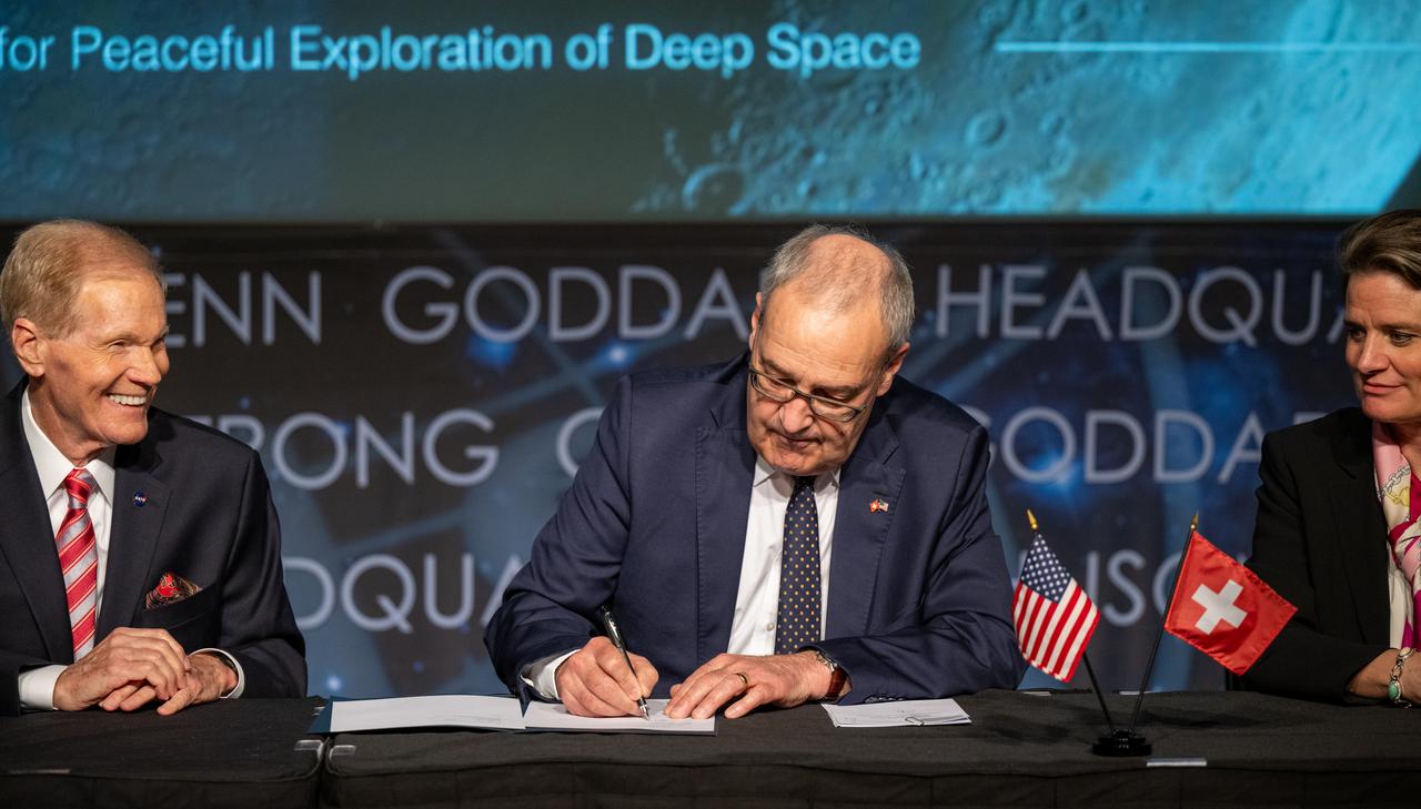 Swiss Federal Councillor Guy Parmelin signs the Artemis Accords as NASA Administrator Bill Nelson, left, and Swiss State Secretary Martina Hirayama, right, look on, Monday, April 15, 2024, at the Mary W. Jackson NASA Headquarters building in Washington. Switzerland is the 37th country to sign the Artemis Accords, which establish a practical set of principles to guide space exploration cooperation among nations participating in NASA’s Artemis program. Photo Credit: (NASA/Keegan Barber)