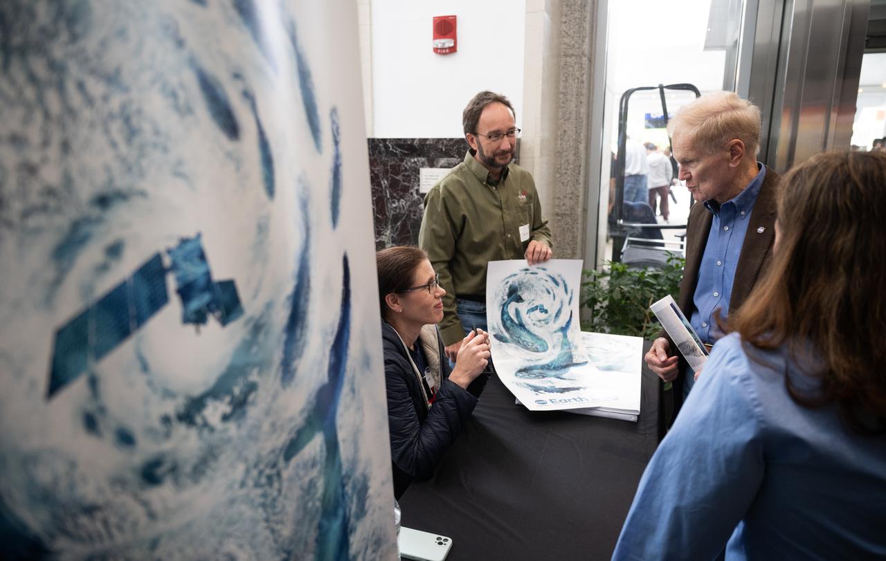 NASA Administrator Bill Nelson, right, speaks with Jenny Mottar, art director for NASA’s Science Mission Directorate, and Kevin Miller, senior graphic designer in the Sciences and Exploration Directorate at NASA’s Goddard Space Flight Center, about the agency’s Earth Day poster as NASA celebrates Earth Day, Friday, April 19, 2024, in the Earth Information Center at the Mary W. Jackson NASA Headquarters building in Washington. Photo Credit: (NASA/Joel Kowsky)