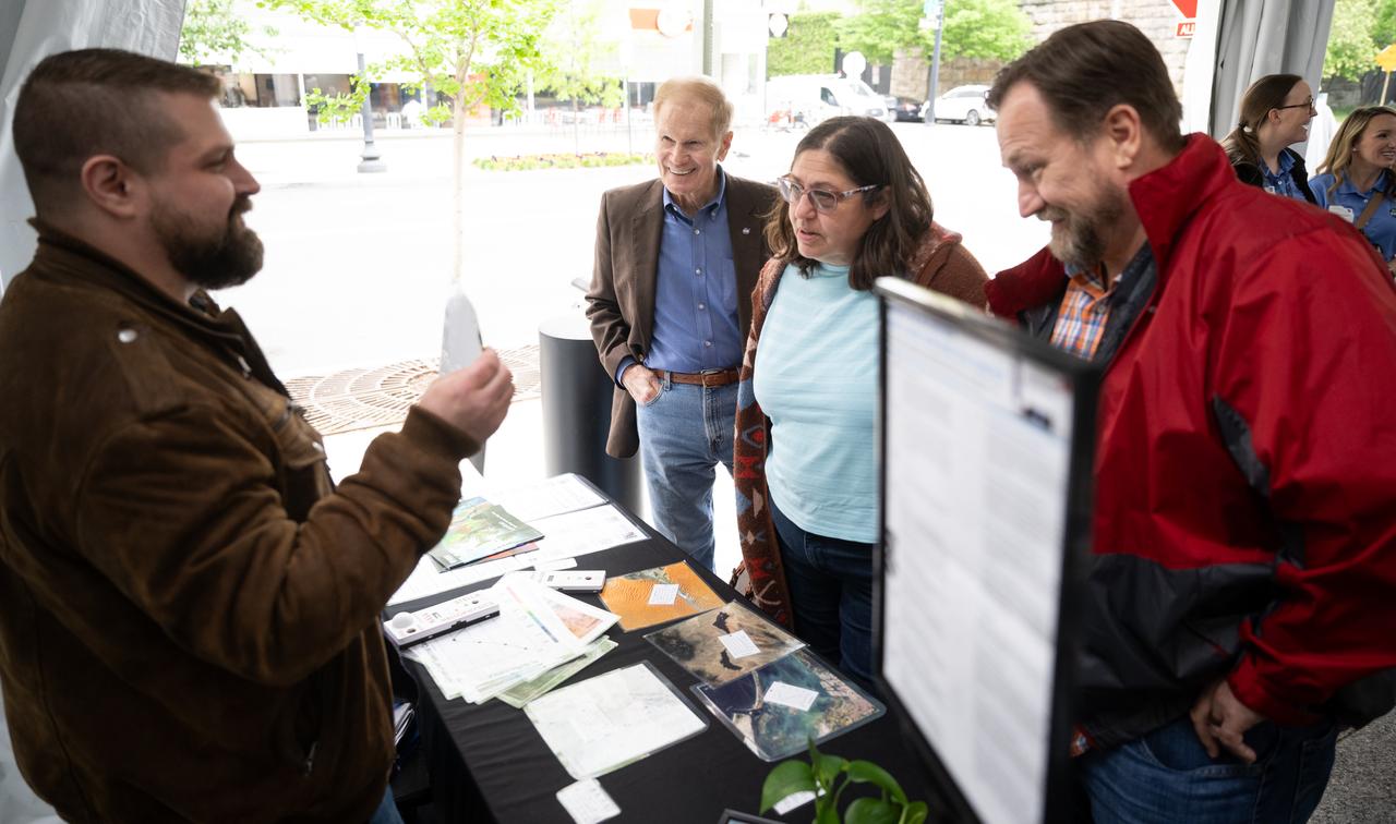 NASA Administrator Bill Nelson, second from right, listens as Michael Taylor from NASA’s Goddard Space Flight Center talks to visitors about Landsat, remote sensing data, and spectral signatures as NASA celebrates Earth Day, Friday, April 19, 2024, in the Earth Information Center at the Mary W. Jackson NASA Headquarters building in Washington. Photo Credit: (NASA/Joel Kowsky)