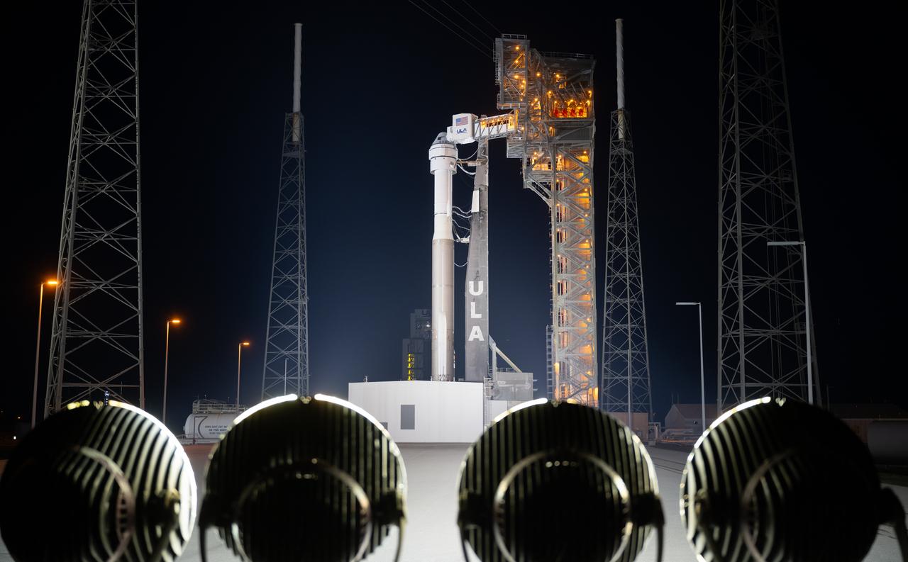 A United Launch Alliance Atlas V rocket with Boeing’s CST-100 Starliner spacecraft aboard is seen on the launch pad illuminated by spotlights at Space Launch Complex 41 ahead of the NASA’s Boeing Crew Flight Test, Sunday, May 5, 2024 at Cape Canaveral Space Force Station in Florida. NASA’s Boeing Crew Flight Test is the first launch with astronauts of the Boeing CFT-100 spacecraft and United Launch Alliance Atlas V rocket to the International Space Station as part of the agency’s Commercial Crew Program. The flight test, targeted for launch at 10:34 p.m. EDT on Monday, May 6, serves as an end-to-end demonstration of Boeing’s crew transportation system and will carry NASA astronauts Butch Wilmore and Suni Williams to and from the orbiting laboratory. Photo Credit: (NASA/Joel Kowsky)