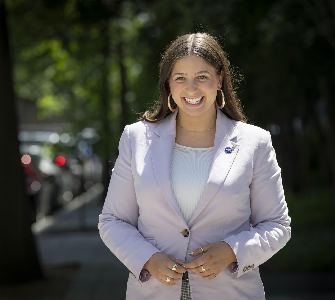 “I feel that my larger purpose at NASA, which I've felt since I came on as an intern, is to leave NASA a better place than I found it. I know there are so many people who are just like myself, who have had this big, huge dream of being at NASA from some sort of spark in their childhood.   I have a privilege as a well-spoken, affable, femme, white woman and I’m compelled to use this privilege for good — to advocate for others. I feel like this dream should be achievable for anyone who has the merit to be here without wondering 'Are my needs going [to] be met?' Or, 'If I'm a part of a particular community, will I be faced with any sort of backlash because of the culture?'  As an Agency, we're trying to do incredibly hard things moving forward. And going forward, I choose to use the privilege of being at HQ and being very close to leadership as a vessel for progress to help ensure we get closer to everybody having the right to achieve their dream here."  NASA Management and Program Analyst Mallory Carbon, poses for a portrait, Wednesday, May 29, 2024, outside the NASA Headquarters Mary W. Jackson Building in Washington. Photo Credit: (NASA/Bill Ingalls)