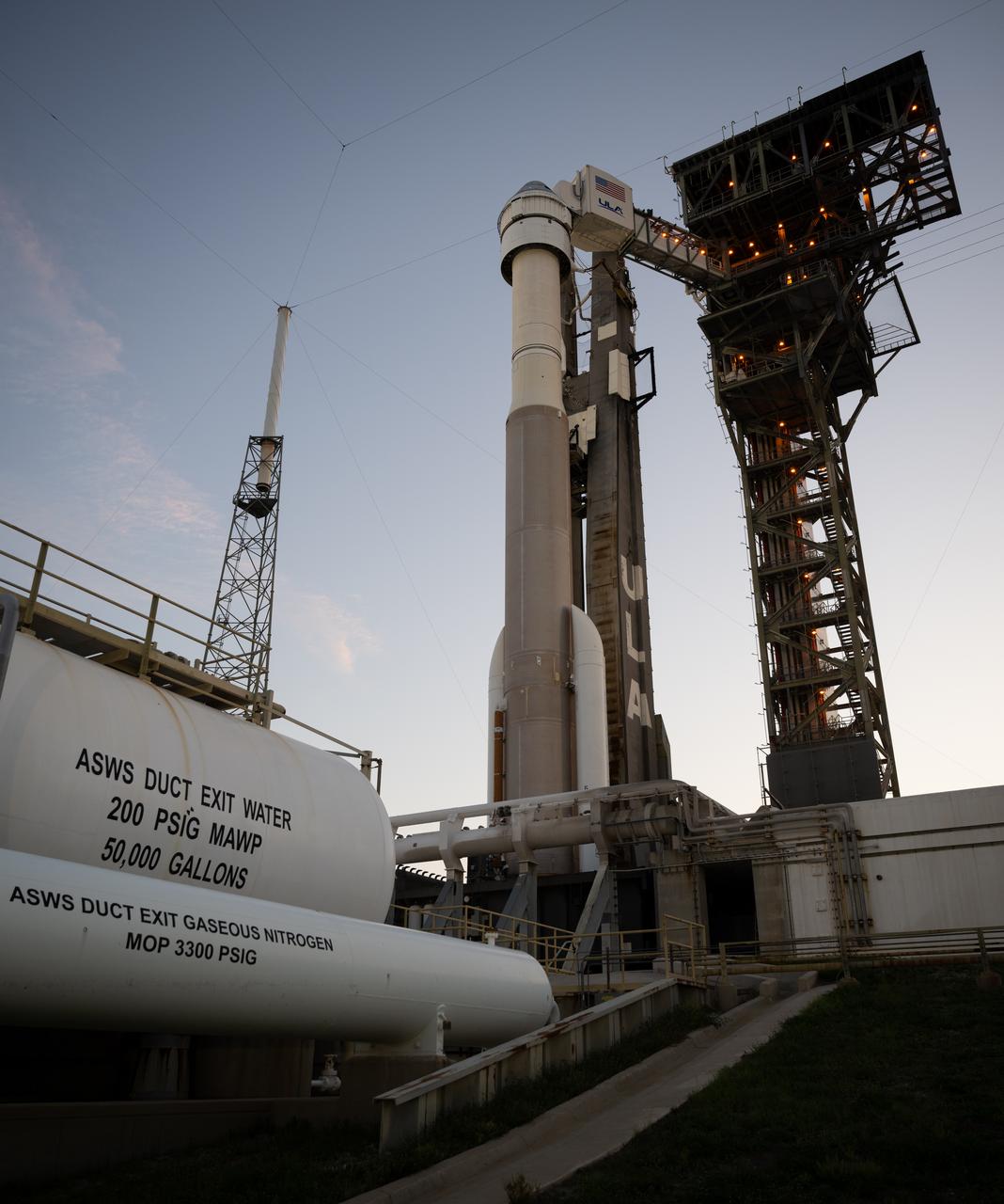 A United Launch Alliance Atlas V rocket with Boeing’s CST-100 Starliner spacecraft aboard is seen at sunset on the launch pad at Space Launch Complex 41 ahead of the NASA’s Boeing Crew Flight Test, Thursday, May 30, 2024 at Cape Canaveral Space Force Station in Florida. NASA’s Boeing Crew Flight Test is the first launch with astronauts of the Boeing CFT-100 spacecraft and United Launch Alliance Atlas V rocket to the International Space Station as part of the agency’s Commercial Crew Program. The flight test, targeted for launch at 12:25 p.m. EDT on Saturday, June 1, serves as an end-to-end demonstration of Boeing’s crew transportation system and will carry NASA astronauts Butch Wilmore and Suni Williams to and from the orbiting laboratory. Photo Credit: (NASA/Joel Kowsky)