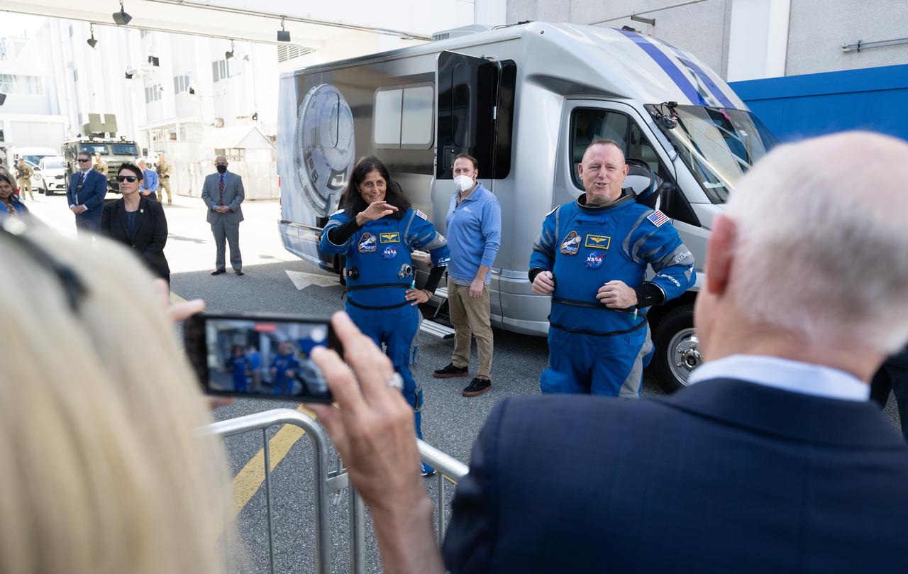 NASA astronauts Suni Williams, left, and Butch Wilmore, wearing Boeing spacesuits, are seen as they speak with NASA, Boeing, and ULA leadership as they prepare to depart the Neil  A. Armstrong Operations and Checkout Building for Launch Complex 41 on Cape Canaveral Space Force Station to board the Boeing CST-100 Starliner spacecraft for the Crew Flight Test launch, Saturday, June 1, 2024, at NASA’s Kennedy Space Center in Florida. NASA’s Boeing Crew Flight Test is the first launch with astronauts of the Boeing CFT-100 spacecraft and United Launch Alliance Atlas V rocket to the International Space Station as part of the agency’s Commercial Crew Program. The flight test, targeted for launch at 12:25 p.m. EDT, serves as an end-to-end demonstration of Boeing’s crew transportation system and will carry NASA astronauts Butch Wilmore and Suni Williams to and from the orbiting laboratory.  Photo Credit: (NASA/Joel Kowsky)