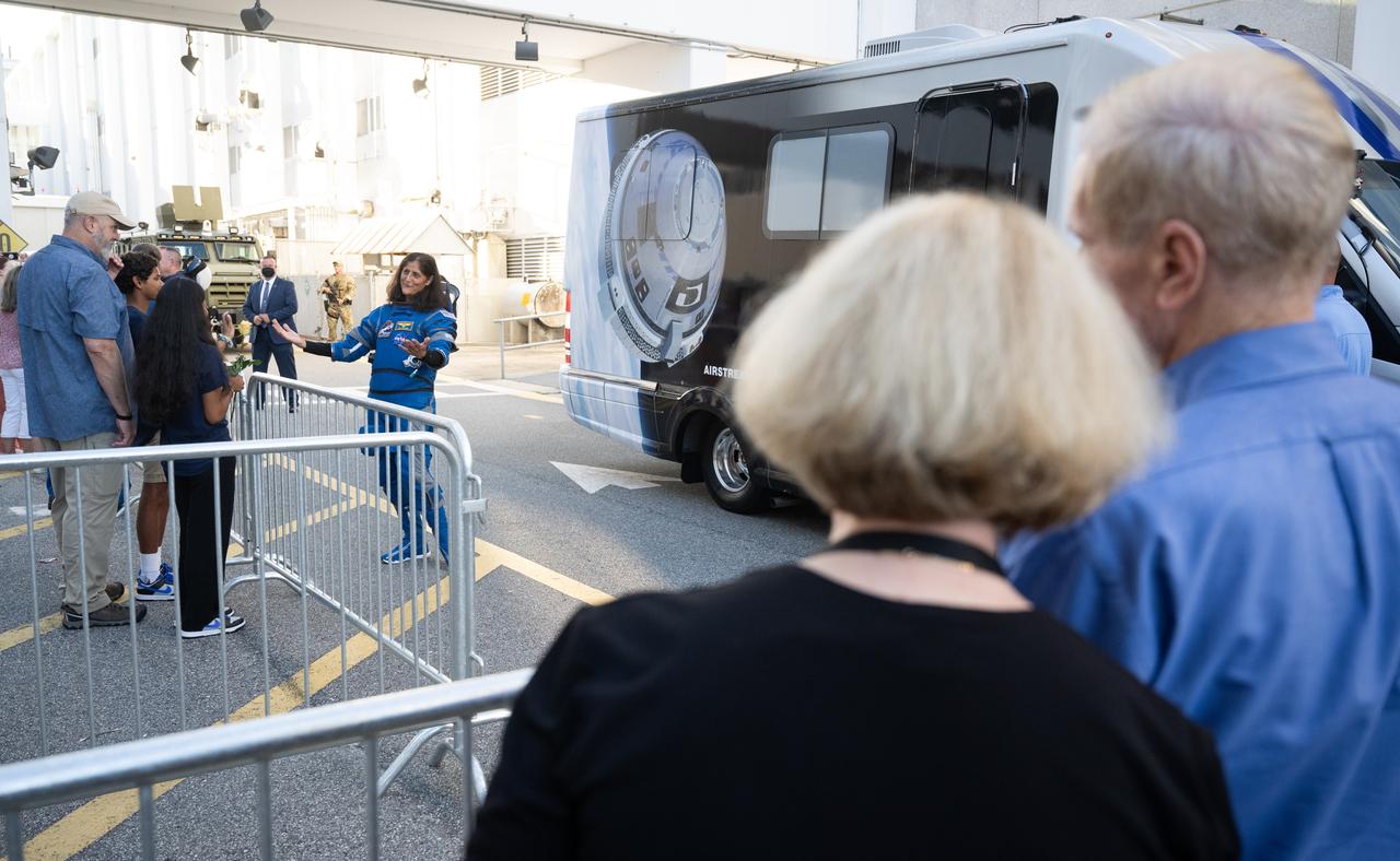 NASA astronaut Suni Williams, wearing a Boeing spacesuit, speaks with her family as she prepares to depart the Neil A. Armstrong Operations and Checkout Building with fellow crewmate NASA astronaut Butch Wilmore for Launch Complex 41 on Cape Canaveral Space Force Station to board the Boeing CST-100 Starliner spacecraft for the Crew Flight Test launch, Wednesday, June 5, 2024, at NASA’s Kennedy Space Center in Florida. NASA’s Boeing Crew Flight Test is the first launch with astronauts of the Boeing CFT-100 spacecraft and United Launch Alliance Atlas V rocket to the International Space Station as part of the agency’s Commercial Crew Program. The flight test, targeted for launch at 10:52 a.m. EDT, serves as an end-to-end demonstration of Boeing’s crew transportation system and will carry Wilmore and Williams to and from the orbiting laboratory. Photo Credit: (NASA/Joel Kowsky)