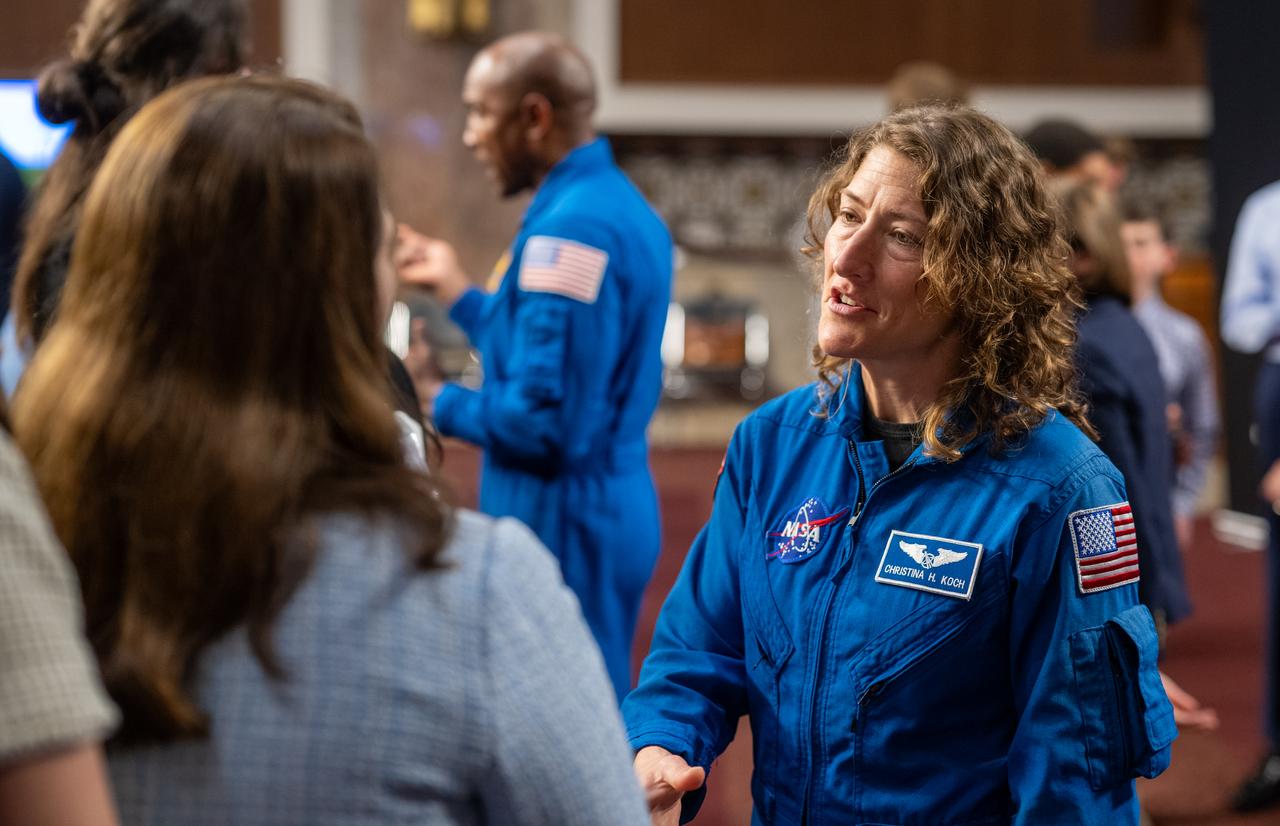 NASA astronaut Christina Hammock Koch, right, shakes hands with a guest during a reception with Artemis II crew members Wednesday, June 5, 2024, at the Dirksen Senate Office Building in Washington. Photo Credit: (NASA/Keegan Barber)