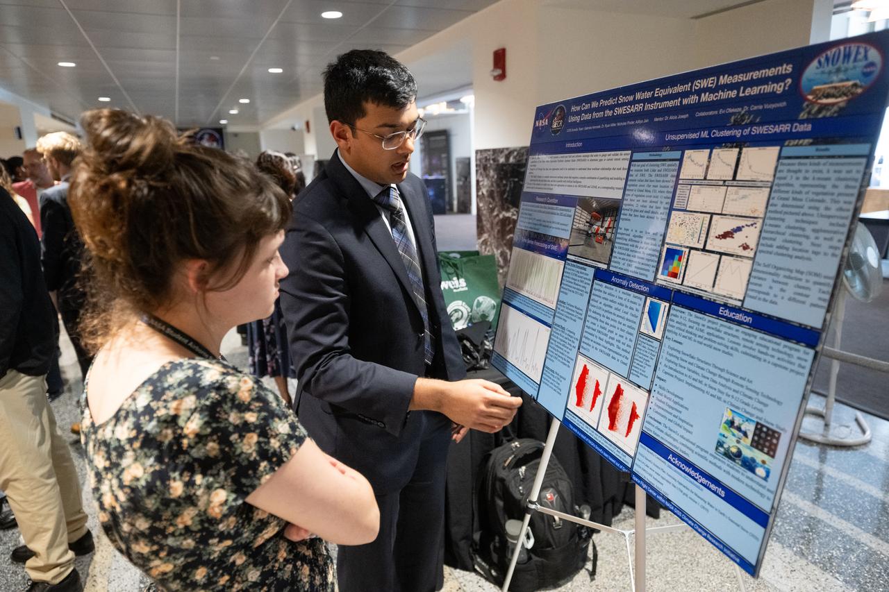 Members of the Climate Change Research Initiative (CCRI) cohort discuss their research during a poster session, Wednesday, Aug. 7, 2024, at the Mary W. Jackson NASA Headquarters building in Washington, DC. The Earth Science Division’s Early Career Research Program’s Climate Change Research Initiative (CCRI) is a year-long STEM engagement and experiential learning opportunity for educators and students from high school to graduate level. Photo Credit: (NASA/Joel Kowsky)