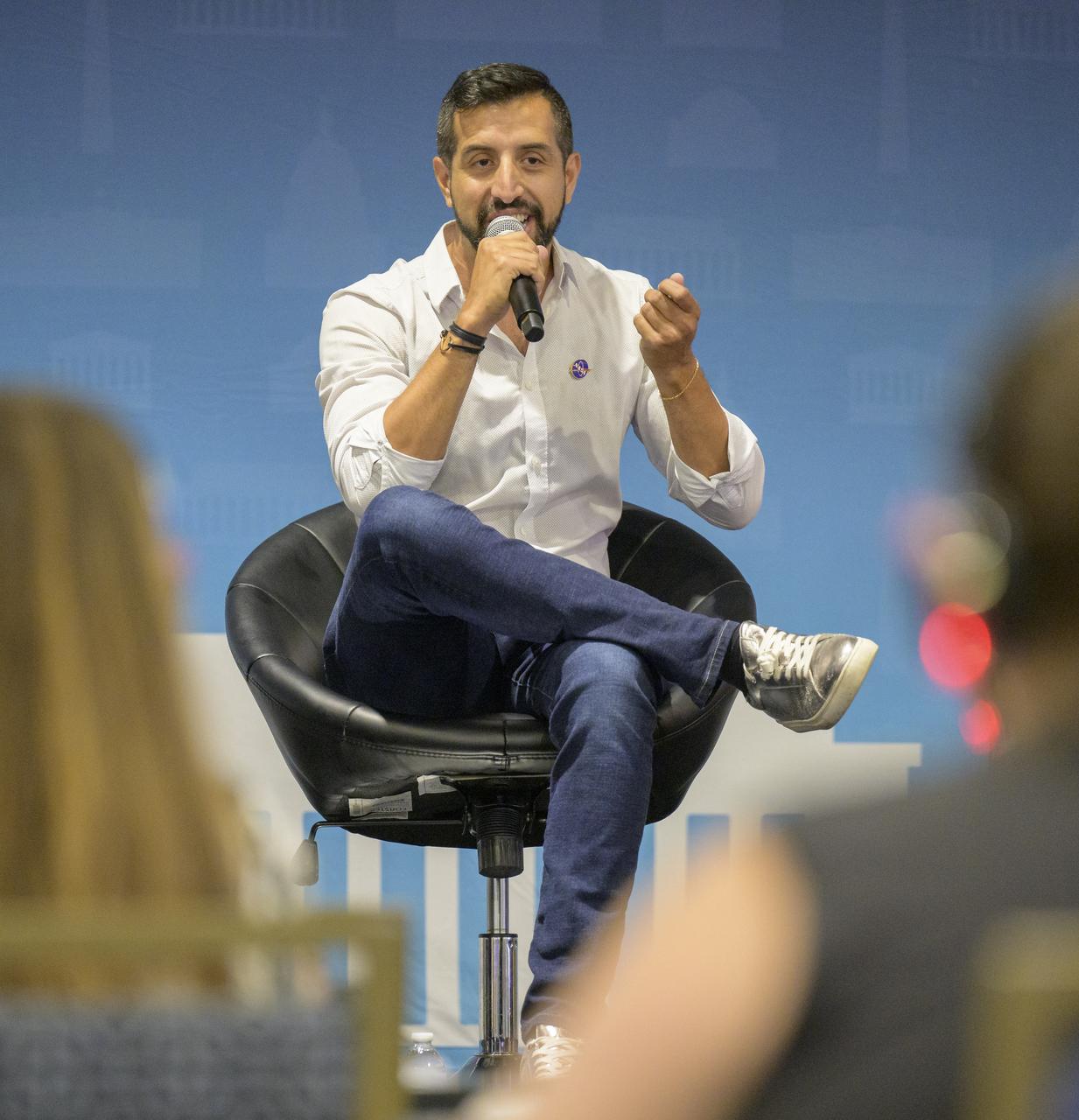 NASA Writer and Host of the Small Steps, Giant Leaps podcast Andrés Almeida is seen during a Podcast Movement, NASA hosted a panel entitled, "Eclipses, Moon Missions, and Climate Change: How NASA Reaches Curious Listeners", Tuesday, Aug. 20, 2024, at the Gaylord National Resort and Convention Center in National Harbor, Md. Photo Credit: (NASA/Bill Ingalls)