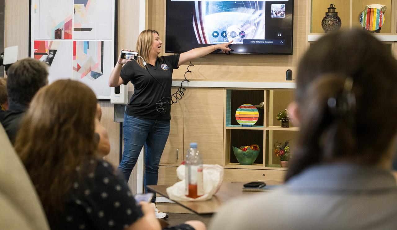 Boeing Astronaut Liaison & Space Flight Awareness Program Manager Megan Donaldson points out NASA’s Boeing Crew Flight Test Starliner spacecraft docked at the International Space Station during a call with NASA astronauts Butch Wilmore and Suni Williams before it’s uncrewed landing, Friday, Sept. 6, 2024, in Las Cruces, New Mexico. It is scheduled to land at White Sands Missile Range’s Space Harbor later today, Mountain Time (Sept. 7 Eastern Time). Photo Credit: (NASA/Aubrey Gemignani)