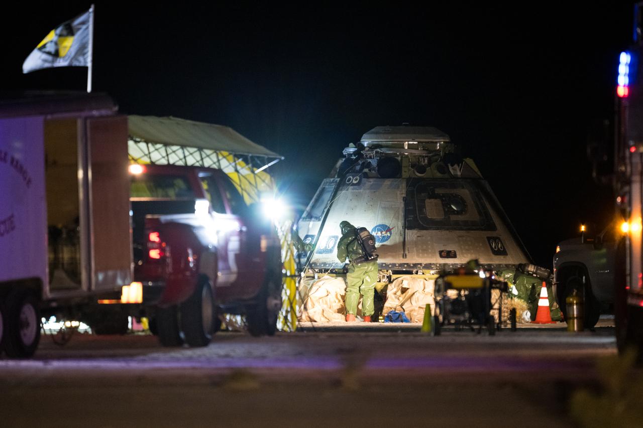 Boeing and NASA recovery teams wait for hazmat teams to confirm it is safe to work around NASA's Boeing Crew Flight Test Starliner spacecraft after it landed uncrewed at White Sands Missile Range’s Space Harbor, Friday, Sept. 6, 2024 Mountain Time (Sept. 7 Eastern Time), in New Mexico. This approach allows NASA and Boeing to continue gathering testing data on the spacecraft. Photo Credit: (NASA/Aubrey Gemignani)
