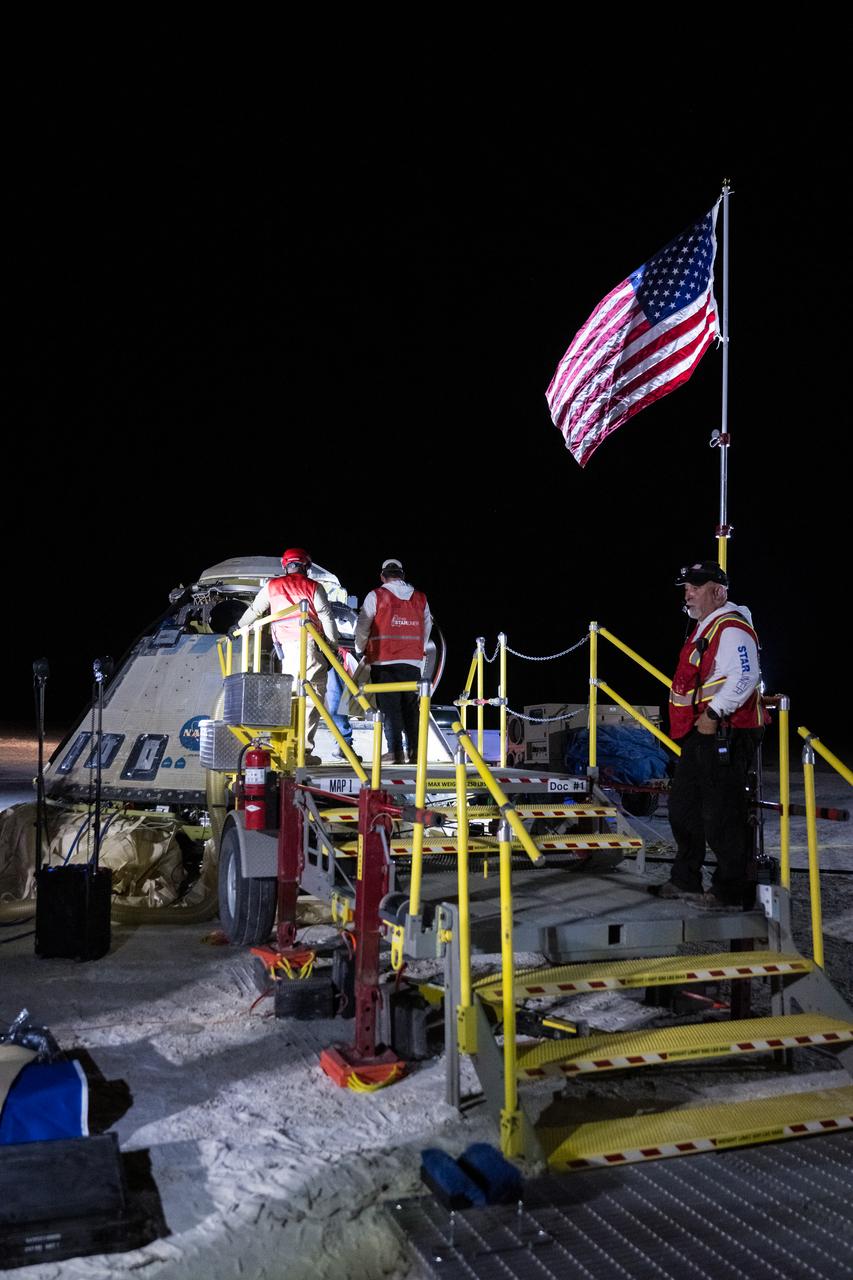 Boeing and NASA teams work around NASA's Boeing Crew Flight Test Starliner spacecraft after it landed uncrewed, Friday, Sept. 6, 2024 Mountain Time (Sept. 7 Eastern Time), at White Sands, New Mexico. This approach allows NASA and Boeing to continue gathering testing data on the spacecraft. Photo Credit: (NASA/Aubrey Gemignani)