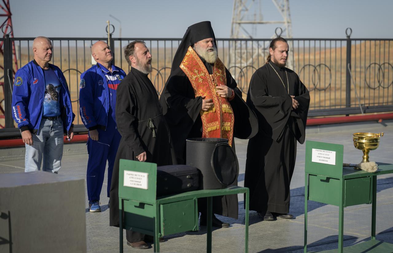 Bishop Ignatii of Kyzylorda and Aktobe, front center, blesses the Soyuz rocket as Roscosmos cosmonauts Oleg Novitsky, back left, and Oleg Artemyev, back right, look on, Tuesday, Sept. 10, 2024, at the Baikonur Cosmodrome site 31 launch pad in Kazakhstan. Expedition 72 crew members: NASA astronaut Don Pettit, Roscosmos cosmonauts Alexey Ovchinin, and Ivan Vagner, are scheduled to launch aboard their Soyuz MS-26 spacecraft on September 11. Photo Credit: (NASA/Bill Ingalls)