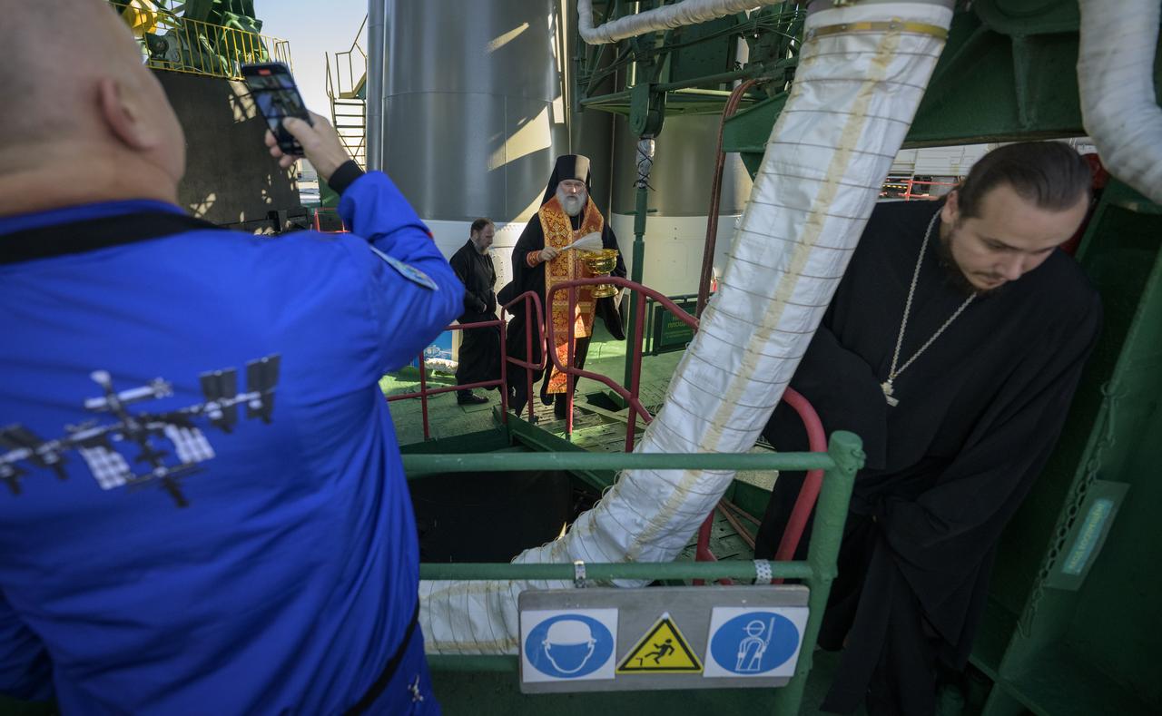 Bishop Ignatii of Kyzylorda and Aktobe blesses the Soyuz rocket, as Roscosmos cosmonaut Oleg Artemyev takes a photograph, Tuesday, Sept. 10, 2024, at the Baikonur Cosmodrome site 31 launch in Kazakhstan. Expedition 72 crew members: NASA astronaut Don Pettit, Roscosmos cosmonauts Alexey Ovchinin, and Ivan Vagner, are scheduled to launch aboard their Soyuz MS-26 spacecraft on September 11. Photo Credit: (NASA/Bill Ingalls)