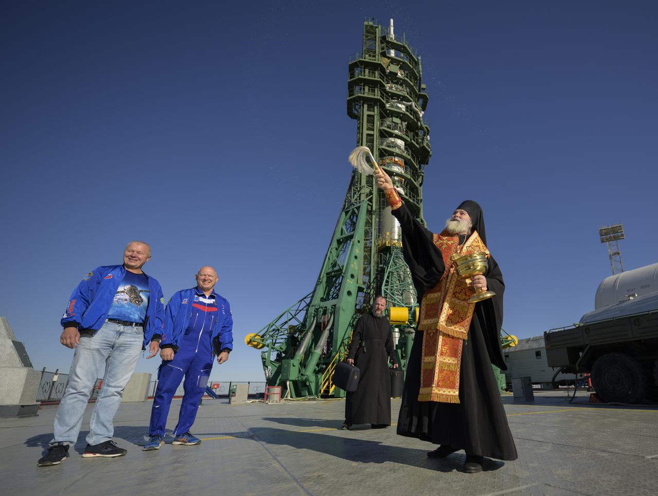 Roscosmos cosmonauts Oleg Novitsky, left, and Oleg Artemyev, participate in the traditional blessing by Bishop Ignatii of Kyzylorda and Aktobe, Tuesday, Sept. 10, 2024, at the Baikonur Cosmodrome site 31 launch pad in Kazakhstan. Expedition 72 crew members: NASA astronaut Don Pettit, Roscosmos cosmonauts Alexey Ovchinin, and Ivan Vagner, are scheduled to launch aboard their Soyuz MS-26 spacecraft on September 11. Photo Credit: (NASA/Bill Ingalls)