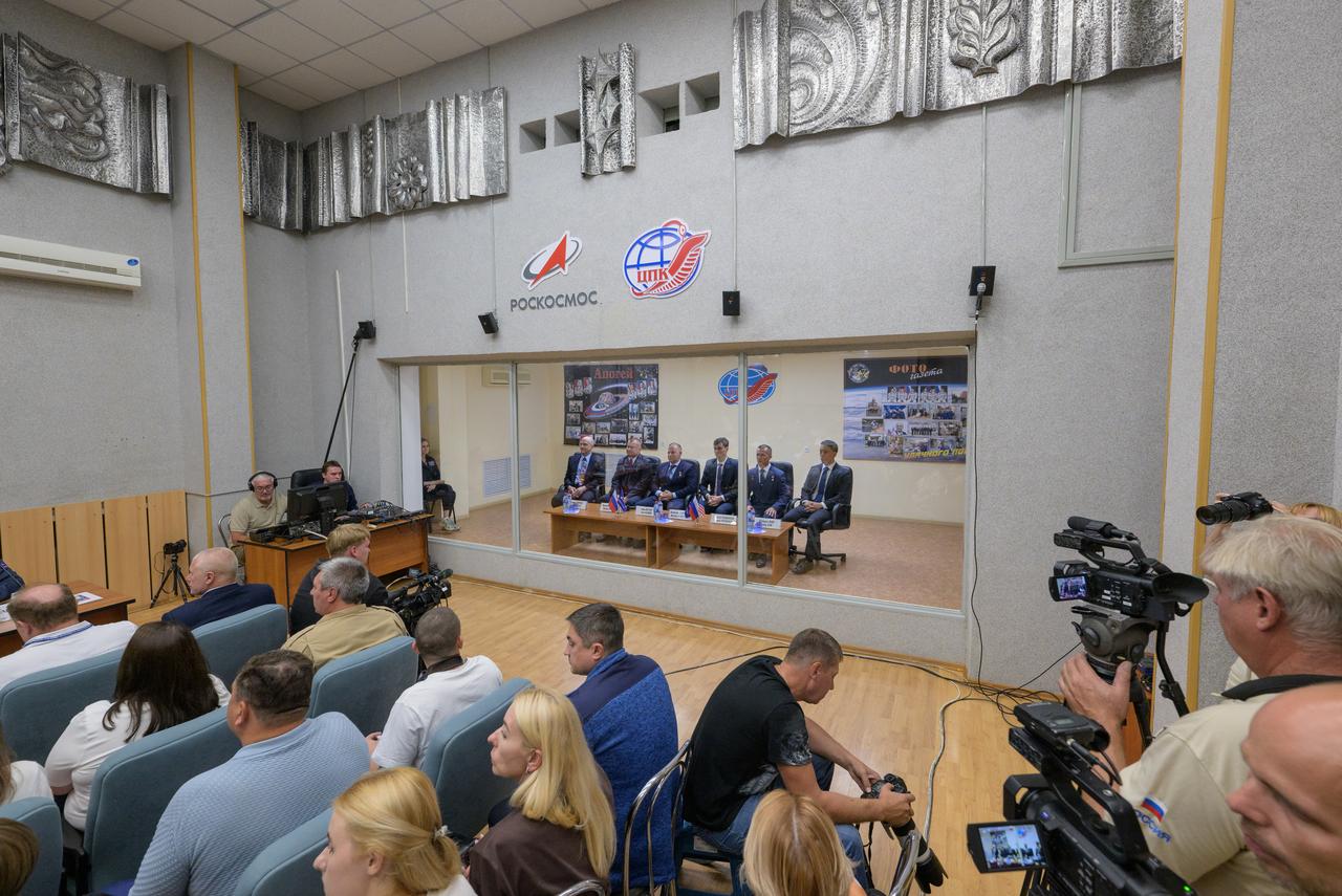Expedition 72 crew members, in quarantine behind glass: NASA astronaut Don Pettit, left, Roscosmos cosmonauts Alexey Ovchinin, and Ivan Vagner, and backup crew members Alexey Zubritskiy, Sergey Ryzhikov, both of Roscosmos, and Jonny Kim of NASA, right, are seen during the State Commission meeting to approve the Soyuz launch of the Expedition 72 crew to the International Space Station, Tuesday, Sept. 10, 2024 at the Cosmonaut Hotel in Baikonur, Kazakhstan. The trio are scheduled to launch aboard their Soyuz MS-26 spacecraft on September 11. Photo Credit: (NASA/Bill Ingalls)