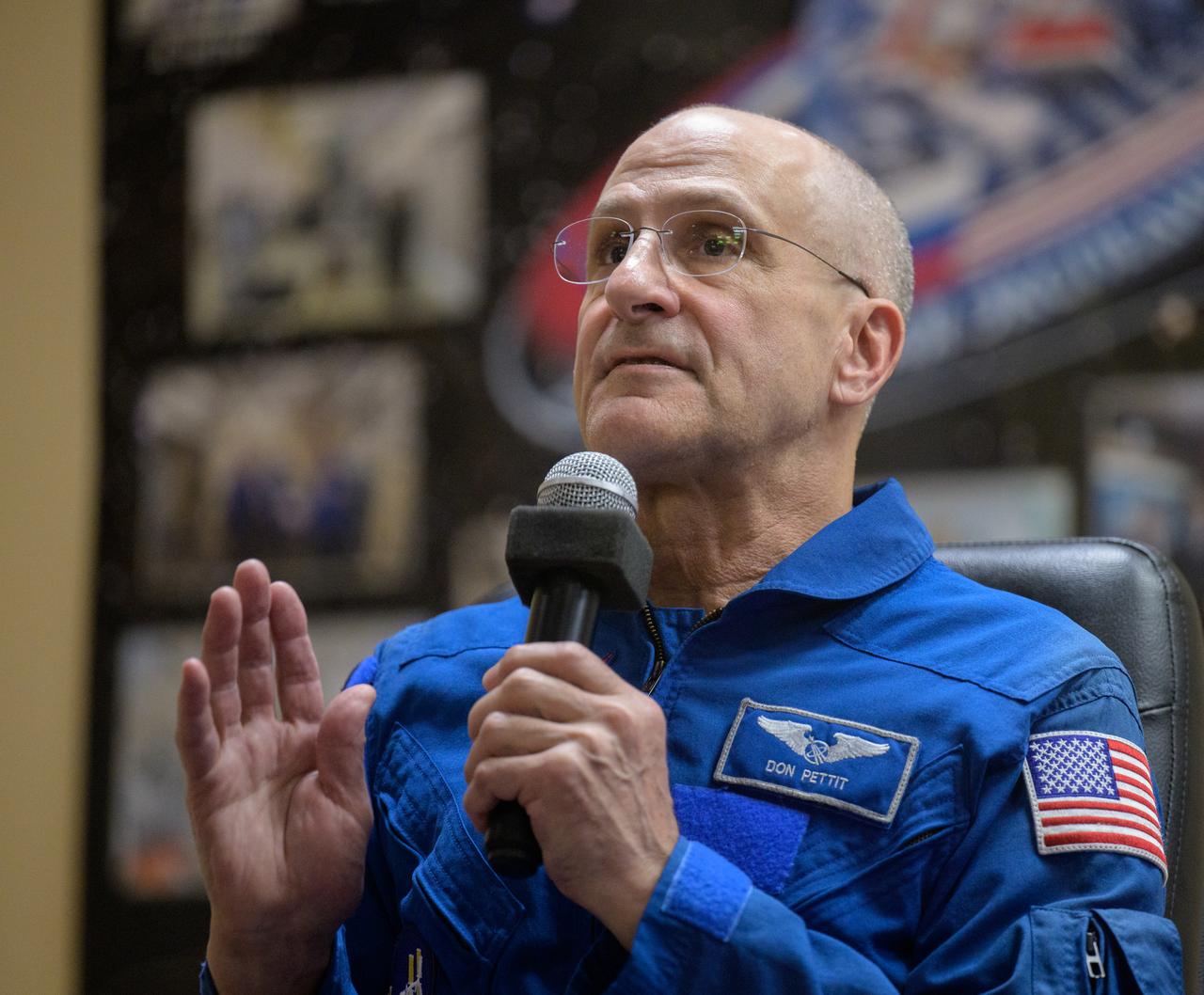 NASA astronaut Don Pettit is seen in quarantine, behind glass, during a press conference, Tuesday, Sept. 10, 2024 a the Cosmonaut Hotel in Baikonur, Kazakhstan. Expedition 72 crew members: NASA astronaut Don Pettit, Roscosmos cosmonauts Alexey Ovchinin, and Ivan Vagner, are scheduled to launch aboard their Soyuz MS-26 spacecraft on September 11. Photo Credit: (NASA/Bill Ingalls)