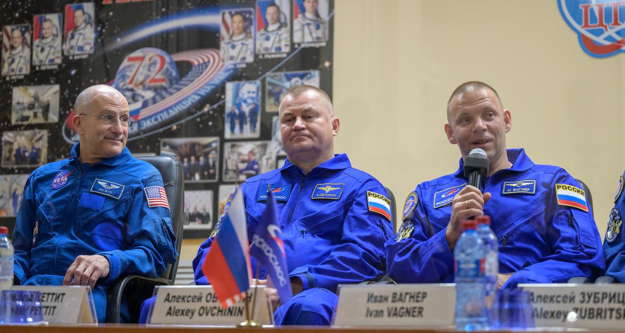 Expedition 72 crew members: NASA astronaut Don Pettit, Roscosmos cosmonauts Alexey Ovchinin, and Ivan Vagner are seen in quarantine, behind glass, during a press conference, Tuesday, Sept. 10, 2024 a the Cosmonaut Hotel in Baikonur, Kazakhstan. The trio are scheduled to launch aboard their Soyuz MS-26 spacecraft on September 11. Photo Credit: (NASA/Bill Ingalls)