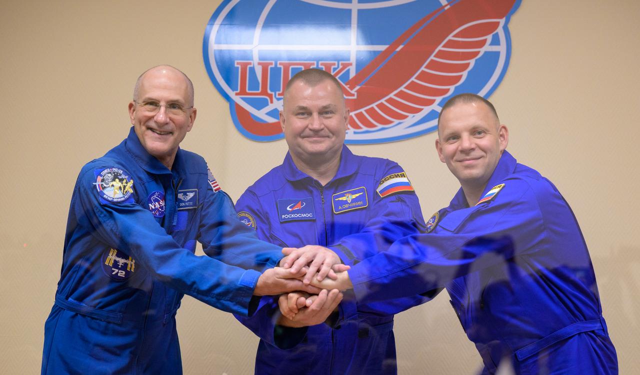 Expedition 72 crew members: NASA astronaut Don Pettit, left, Roscosmos cosmonauts Alexey Ovchinin, and Ivan Vagner, right, are seen in quarantine, behind glass, during a press conference, Tuesday, Sept. 10, 2024 a the Cosmonaut Hotel in Baikonur, Kazakhstan. The trio are scheduled to launch aboard their Soyuz MS-26 spacecraft on September 11. Photo Credit: (NASA/Bill Ingalls)