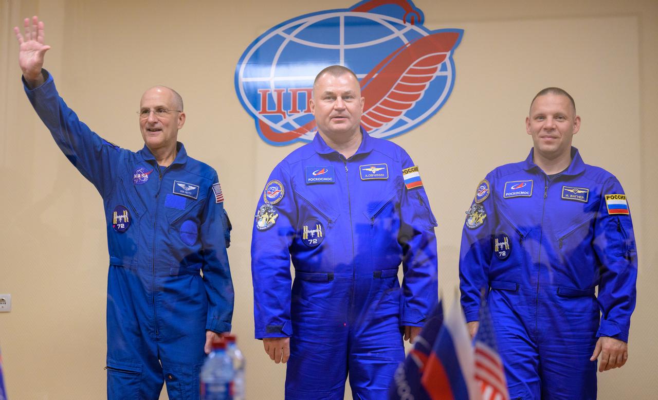Expedition 72 crew members: NASA astronaut Don Pettit, left, Roscosmos cosmonauts Alexey Ovchinin, and Ivan Vagner, right, are seen in quarantine, behind glass, during a press conference, Tuesday, Sept. 10, 2024 a the Cosmonaut Hotel in Baikonur, Kazakhstan. The trio are scheduled to launch aboard their Soyuz MS-26 spacecraft on September 11. Photo Credit: (NASA/Bill Ingalls)