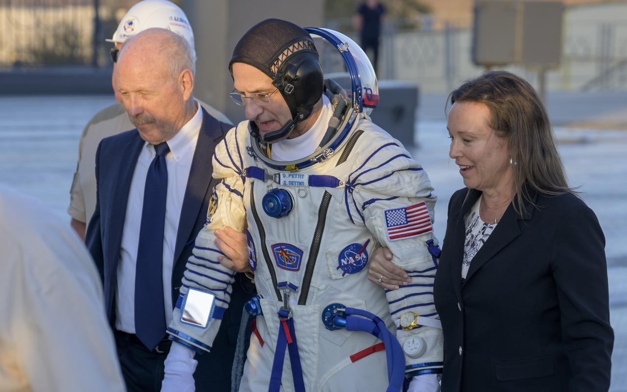 NASA Associate Administrator for the Space Operations Mission Directorate, Ken Bowersox, left, and NASA International Space Station Program Deputy Manager, Dina Contella, right, walk NASA astronaut Don Pettit to the Soyuz rocket for boarding, Wednesday, Sept. 11, 2024 at the Baikonur Cosmodrome in Kazakhstan. The launch of Pettit along with Roscosmos cosmonauts Ivan Vagner and Alexey Ovchinin will send the trio on a mission to the International Space Station. Photo Credit: (NASA/Bill Ingalls)