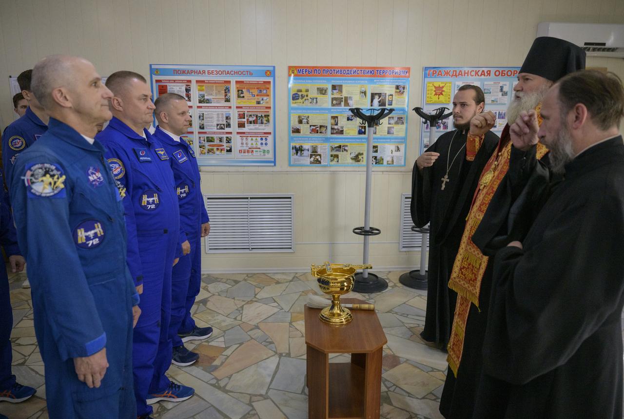 Expedition 72 crew members: NASA astronaut Don Pettit, left, Roscosmos cosmonauts Alexey Ovchinin, and Ivan Vagner, right, receive the traditional blessing at the Cosmonaut Hotel prior to departing for suit-up and launch on a Soyuz rocket, Wednesday, Sept. 11, 2024, in Baikonur, Kazakhstan. The launch will send Pettit, Ovchinin, and Vagner on a mission to the International Space Station. Photo Credit: (NASA/Bill Ingalls)