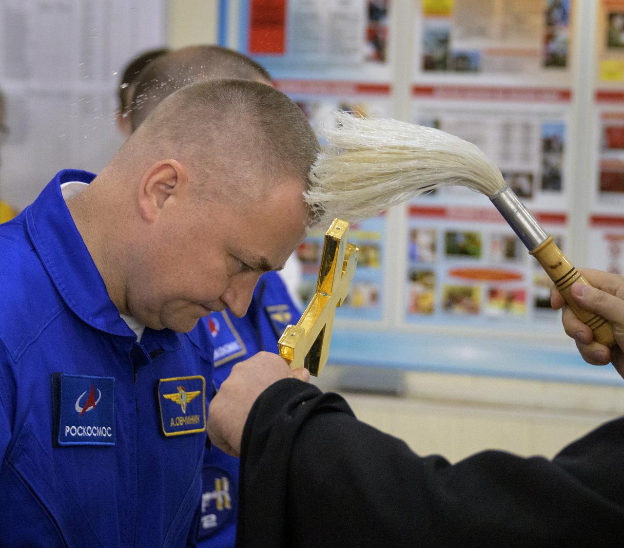 Roscosmos cosmonaut Alexey Ovchinin receives the traditional blessing at the Cosmonaut Hotel prior to departing for suit-up and launch on a Soyuz rocket with fellow crew mates, Roscosmos cosmonaut Ivan Vagner, and NASA astronaut Don Pettit, Wednesday, Sept. 11, 2024, in Baikonur, Kazakhstan. The launch will send Pettit, Ovchinin, and Vagner on a mission to the International Space Station. Photo Credit: (NASA/Bill Ingalls)