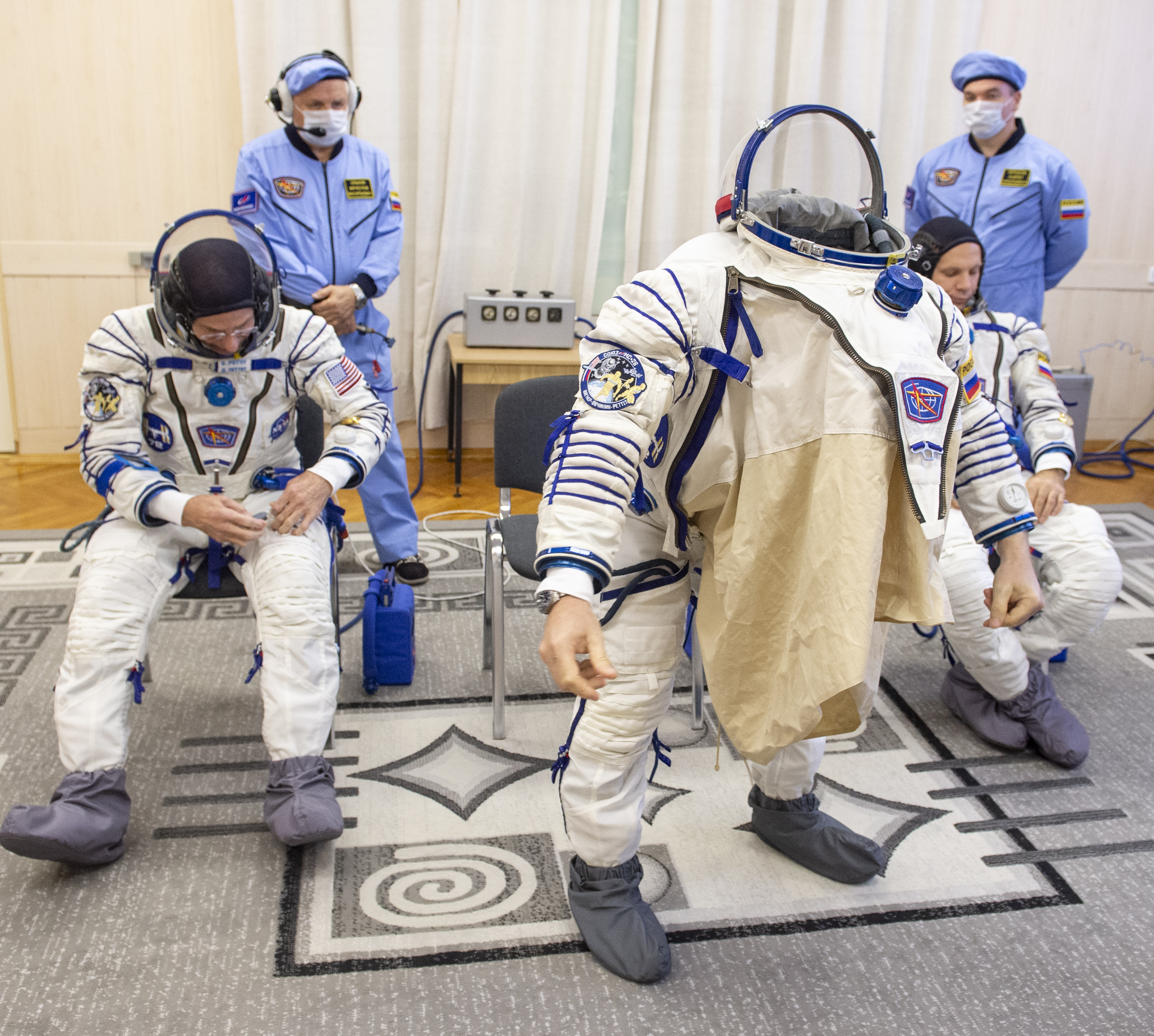 Roscosmos cosmonaut Alexey Ovchinin, center, dons his Russian Sokol suit as and fellow crew mates, NASA astronaut Don Pettit, left, and Roscosmos cosmonaut Ivan Vagner, prepare for their Soyuz launch to the International Space Station Wednesday, Sept. 11, 2024 in Baikonur, Kazakhstan. The launch will send Pettit, Ovchinin, and Vagner on a mission to the International Space Station. Photo Credit: (NASA/GCTC/Andrey Shelepin)